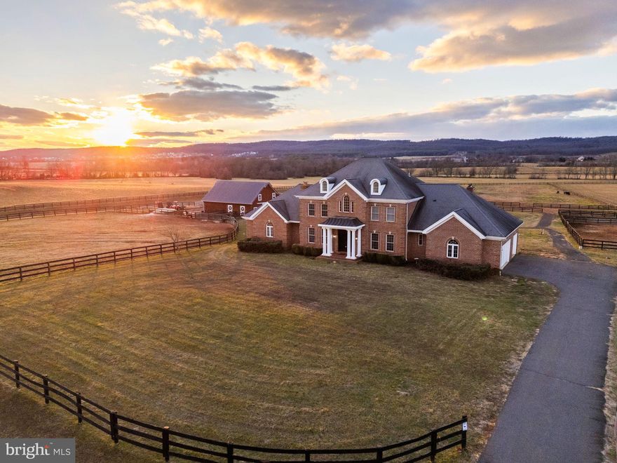 Discover a rare opportunity to own a working equestrian estate on over 10 private acres, just minutes from historic downtown Leesburg. This expansive 6-bedroom, 4.5-bath residence offers approximately 6,800 square feet on three finished levels, and main floor master bedroom.  

Inside, the main level is graced with crown molding and chair rail detail, anchored by a large kitchen that serves as the heart of the home. The open, flowing layout is ideal for both intimate gatherings and larger-scale entertaining.

Designed with horse lovers in mind, the property boasts a custom 6-stall barn featuring a spacious loft, well-appointed tack room with electric and water, a dedicated wash stall, and convenient auto-waterers. Outdoors, find seven fully fenced pastures - including two generous 3-acre fields - additional turnout areas, a run-in shed, a two-stall shed, and a 150’ x 75’ outdoor arena. All fencing and pasture improvements were added around 2016.

Seize this turnkey equestrian retreat offering privacy, scenic views, and easy access to Leesburg’s vibrant amenities. Whether for your own horses or rental income from boarding and pasture space, this is a truly exceptional offering in a coveted location.  Note the property border outline in the photos is approximate and not official.