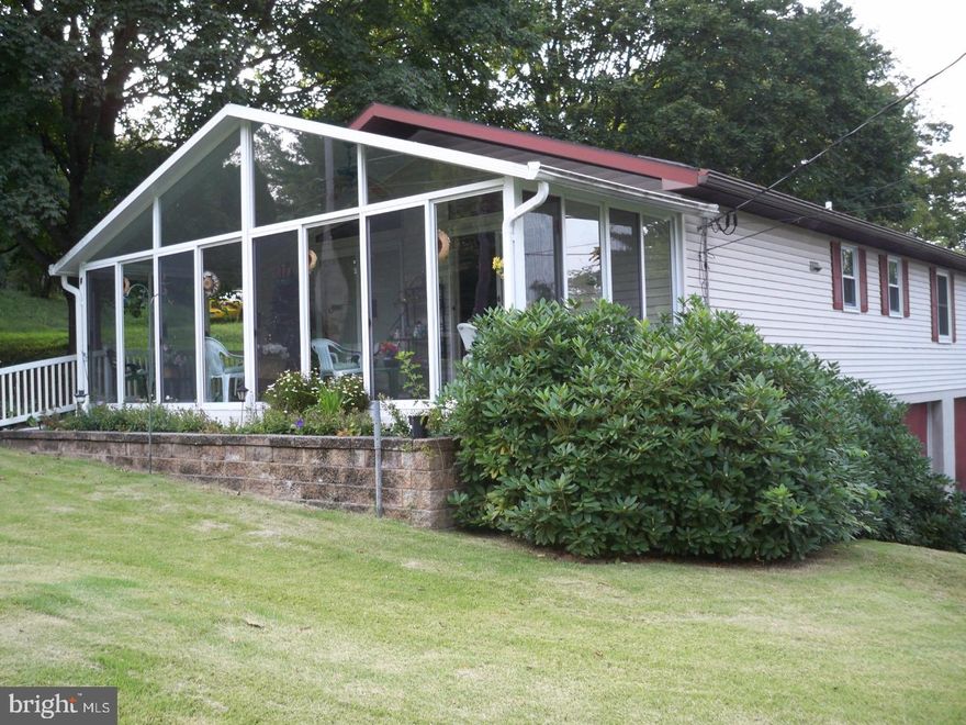 Lovely 3 Bedroom, 2 Bath home located in Blue Mountain School District.  Open floor plan with spacious living room and eat-in kitchen with cathedral ceilings.  Could also be used as kitchen/dining room.  Large Sun room that provides heat all year.  Basement stays dry with B-Dry. Home is equipped with gutter helmets.  Nice deck off rear bedroom with sliding glass doors. Large Yard.  Central Air. Two-car attached garage with extra parking.  Call to schedule your private tour.