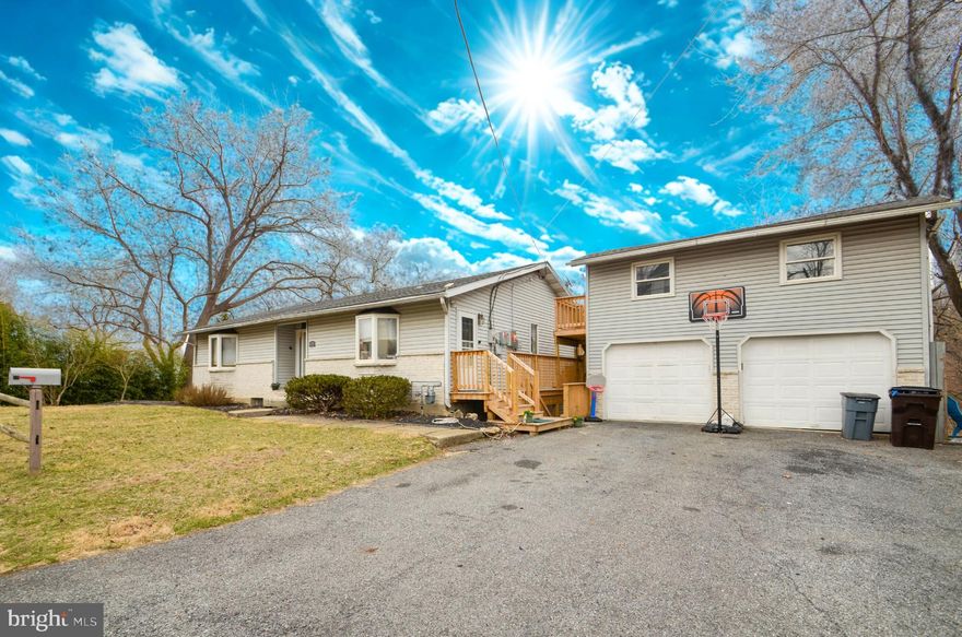 This one-of-a-kind home is a must-see, offering breathtaking views and endless potential. Designed for entertaining, the home is filled with natural light thanks to a stunning two-story wall of windows. A massive wraparound deck, with sections spanning three levels, provides incredible outdoor living space. Inside, you'll find three bedrooms, three full bathrooms, a spacious family room, and a striking floating bonus room. The interior has been updated with neutral beige paint and white trim, new vanities in two refreshed bathrooms, and recently replaced carpeting, excluding the bedrooms. The kitchen features newer appliances, and the HVAC system, installed in 2020, includes a heat pump for year-round comfort. The exterior combines siding with beautiful stone accents for added charm. The oversized two-bay garage presents a unique opportunity. Already gutted with separate heat and electric installed, it offers flexibility for future expansion. While the space above the garage is currently unpermitted, with the right approvals, the property has the potential for two additional living spaces—making it an excellent investment opportunity or a perfect setup for an owner-occupant with an in-law suite. With an expansive layout, modern updates, and a location with stunning views, this property is full of possibilities. Schedule a showing today to experience everything it has to offer! Property is being sold as-is. Contact us today!