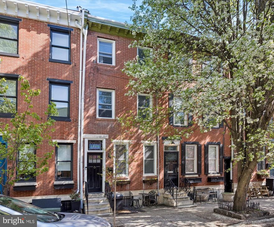 Welcome to this beautifully newly renovated three-story townhome in the highly sought-after Queen Village neighborhood of Philadelphia. Blending modern design with thoughtful upgrades, this home offers stylish city living across every level. The main floor features an open-concept layout with sleek hardwood flooring and a striking staircase with designer railing that serves as a true focal point. The kitchen is both functional and eye-catching, complete with white shaker cabinetry, stainless steel appliances, black granite countertops, and elegant gold-tone hardware. A stylish powder room completes this level. Upstairs, the second floor offers two generously sized bedrooms and a beautifully finished full bathroom with contemporary tilework and modern fixtures. The entire level continues the clean, cohesive feel with updated flooring and abundant natural light. The top floor is dedicated to a private primary suite, offering a peaceful retreat with its own spa-like bathroom featuring a highlighted mirror and refined finishes. The finished basement provides additional flexible living space—perfect for a home office, gym, or media room—featuring a modern accent wall and sliding barn door detail. Step outside to a truly unique backyard oasis, complete with a custom pergola and thoughtfully designed fencing—ideal for relaxing or entertaining. Additional upgrades include updated electrical, plumbing, HVAC, roof, and front windows. This move-in-ready home is just steps from parks, playgrounds, cafés, and neighborhood favorites. Lovingly maintained, it offers the perfect balance of space, comfort, and location—ready to welcome its next owner.