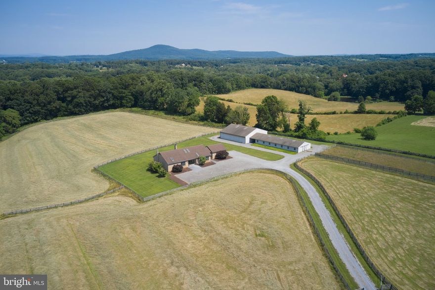First time on the market - 25 acre farm located in the Poolesville School District and Montgomery County's Agricultural Reserve.  Designed by an equestrian this property offers horse stable, indoor ring, 4 board fencing, majority of land in pastures.  Plus, a  custom built all brick rancher,  3 BR, 2.5 BA sited on the property to take advantage of the pastoral and mountain views.  Stainless steel appliances,  open floor plan, first level laundry and  house generator.    A nine stall horse stable, fully matted aisle, 12 x 12 stalls with mats, tack room, feed room, wash stall and office with kitchenette and bath.  The 60 x 60 indoor ring is attached by a covered walk way making it accessible to the stable without facing the outside elements.  Outdoor ring is located by the stable.  Three large pastures with 4 board wood fencing.  Hay field is approximately 11 acres.  Fabulous location for schools , catching the MARC Train and commuting.  Ride your horse to the Potomac Hunt Club. And take advantage of the Rickman/Greenberg Horse Park plus minutes to Loch Moy Equestrian Center.