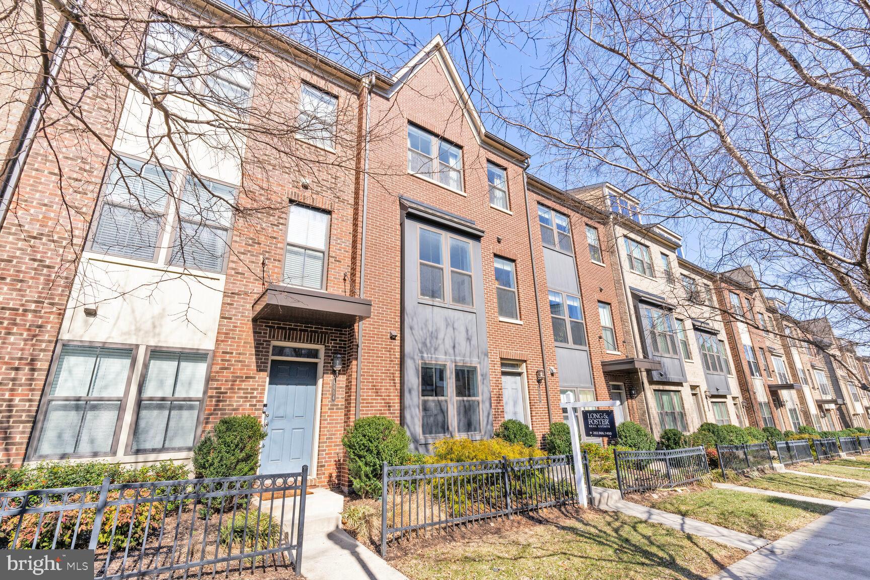OFFERED FURNISHED! Welcome to this terrific, "like-new" 4-level townhouse located in the highly desirable and trendy Riverdale Park neighborhood! Situated on a prime lot backing to trees, this home provides full privacy and tranquility, yet is within walking distance to all the amenities!! Built in 2017 and very lightly lived in, this townhouse feels practically brand new. The entry level features a foyer with a den/office and a large one-car garage with ample storage space. The first floor offers a spacious and open floor plan with soaring ceilings, with the gourmet kitchen at the center. The kitchen includes an expansive island with high-end countertops, tall white cabinets, and stainless steel appliances. The living room opens to a balcony, where you can enjoy private views to the back. The living and dining areas are laid out on either side, creating an ideal space for entertaining or daily life. Recessed lighting, crown moldings, and a half bath complete this level. The second level features two spacious bedrooms, including a primary bedroom with a private ensuite bath. This level also has a hall bath with a large linen closet in the hallway. The third level offers a lovely loft with glass doors leading to the roof terrace. This versatile space can be used as a den, TV room, or additional THIRD bedroom. The serene, private roof terrace truly feels like a getaway. There is plenty of street parking for guests, and right outside your door, you'll find Whole Foods, Gold's Gym, Starbucks, and a variety of dining options. You'll also find a bike share station at one end of the community and a delightful playground, plus a Snail Trail at the other end. The fantastic Trolley Trail runs through the community, perfect for biking, running, and walking. The College Park Metro and the MARC train are just half a mile away, accessible via the walking and bike path right outside your door. The University of Maryland is less than 10 minutes away, and there’s a free daily shuttle to College Park and Prince George’s Plaza metros. It doesn’t get more convenient than this!