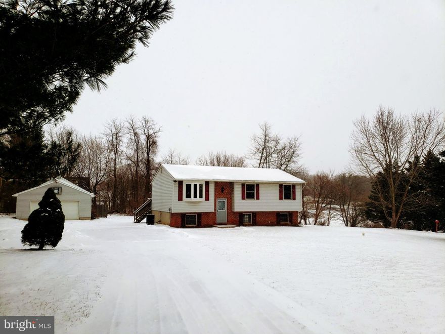 3 bedroom 2 bath Split Foyer, with 3+ car, 600 Square Foot Detached Garage. Full Bath in Master! Deck off of Kitchen and Covered Porch on basement level. Newer Carpet throughout. Large, Level lot, nice neighborhood. Large front, side and back yards!  Basement is unfinished, but sheds a lot of natural light w/ newer windows and Andersen French Doors.  Basement is ready for your finishing touches--Plenty of room for an additional family room, bath and bedrooms!  Surrounded by mature trees for privacy. Over 1 acre in Finksburg, with a garage!!