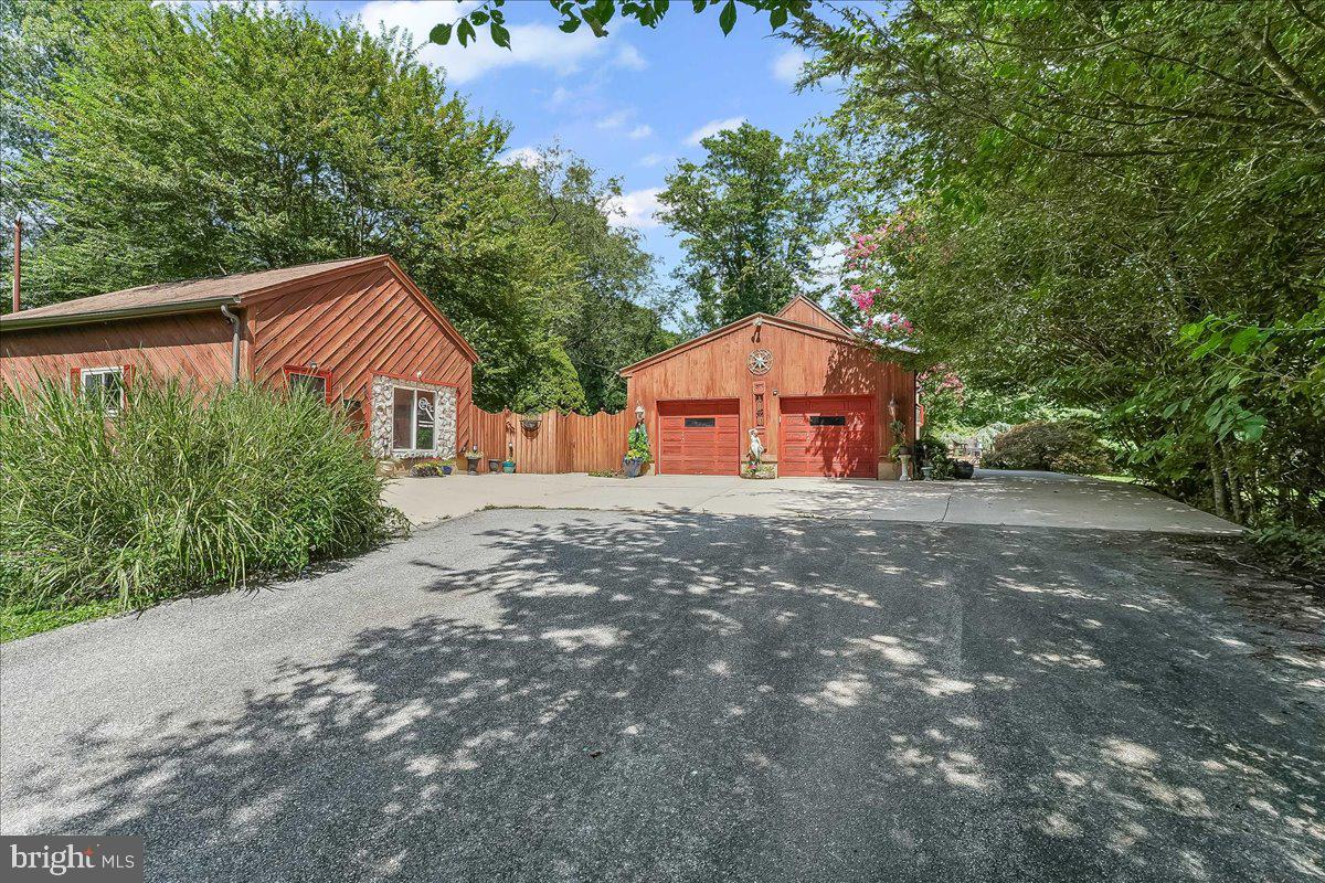 A rare opportunity in a prime location - perfect for professionals and nature lovers alike. Nestled just off Route 1 and a stone's throw from iconic Longwood Gardens, this unique 1.5 acre property features two dwellings on one parcel a beautifully crafted Cape Cod style Maine Post and Beam home and a separate 700 ft² private office just steps from your door, whether you're a consultant, therapist ,designer , or remote worker ,this setup is a dream come true.
Enjoy the benefits of a highly visible signage on Route 1, while maintaining complete privacy. A 600 ft private drive leads to your tranquil sanctuary tucked away and meticulously maintained through an existing shared agreement with the neighboring property.
The grounds are nothing short of magical, complete with heart-shaped pond with waterfall , lighted gazebo, and expansive open space, ideal for relaxation, reflection or small gatherings.
This three-bedroom 2.5-bathroom home offers warm and inviting living spaces across three levels.
First floor: Cozy living room with gleaming hardwood floors, a bank of new windows with a window seat, a Valley Forge white stone fireplace, formal dining room, full eat in kitchen with hardwood floors a garden window and custom copper backsplash and a flexible first floor bedroom currently used as an office, as well as a full bath with a stall shower, as well as a formal dining room.
Second floor: private main suite with jacuzzi whirlpool tub and handheld shower, loft overlook, currently being used as a dressing room, but also perfect for reading nook, creative space or office extension.
Lower level: expansive third bedroom with half bath, large family room with wet bar, and additional flexible space for guests to enjoy. Natural light pours in through seven skylights, all outfitted with custom shades. The homes character is further enhanced by quality craftsmanship, post and beam details,
(see more details on UPGRADES AND SPECIAL FEATURES in Bright additional paperwork) and a sense of welcoming comfort throughout.
There is an attached oversized two-car garage with workbench, ideal for the hobbyist or handyman. Enjoy Your morning cup of coffee and you're lazy summer evening views from your scenic brick patio, as well as the spectacular Longwood fireworks view, five times a year, on your sprawling deck which is also the perfect spot for entertaining and hosting large gatherings.
The second dwelling is a private office with a half bath, a waiting room, a administrative assistant's room, and two separate offices. Parking is plentiful.
This one-of-a-kind property blends professional convenience with personal serenity, all in an unbeatable location. You truly must see it to appreciate the lifestyle it offers.
Schedule your private tour today.
