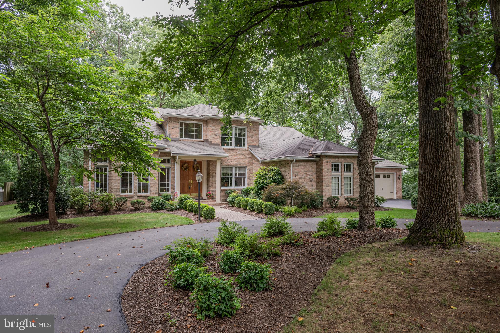 Discover an exquisite blend of elegance and comfort in this stunning Colonial residence nestled in the prestigious Wakefield Valley. Spanning 3,982 square feet, this meticulously maintained home boasts four spacious bedrooms and 2.5 luxurious bathrooms, offering an unparalleled living experience. Step inside to find an inviting open floor plan adorned with rich wood floors and exposed beams, creating a warm and welcoming ambiance. The gourmet kitchen is a chef's dream, featuring upgraded countertops and appliances, a central island, and a cozy breakfast area, perfect for casual dining. Entertain effortlessly in the formal dining room or unwind in the family room, complete with elegant fireplaces, framed with glass doors and mantels. Retreat to the primary suite, where a lavish walk-in closet and a spa-like bathroom with a walk-in shower await. Enjoy the convenience of a main-floor laundry and a partially finished basement, offering endless possibilities for recreation or relaxation. Outside, the property is a true sanctuary, set on 1.46 acres that backs to serene woods, providing a tranquil backdrop. Extensive hardscaping and outdoor lighting enhance the exterior, while a spacious deck and patio invite you to savor the beauty of nature. With a circular driveway and a four-car garage, this home combines luxury with practicality. Experience the exclusive lifestyle this remarkable property offers, where every detail has been thoughtfully curated for your enjoyment. Don't miss the opportunity to make this dream home yours!