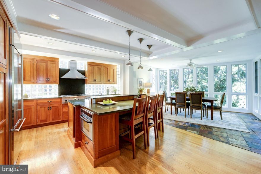 Colonial on the outside and utterly fabulous on the inside. Spectacular three story addition by award-winning architect Steven Vanze. Stunning family room addition with a breakfast room in the treetops.  Generous room proportions are ideal for entertaining or comfortable living.  The breathtaking master bedroom suite has two full walls of windows with treetop views, en-suite bath, and walk-in closet. The LL is finished with a cozy family room w/fp, a perfect play area, a guest suite and full bath. Extras include a custom mudroom, an intimate screen porch and storage. The multi-level decks with multiple seating areas are impressive. This house is beyond unique. Plan to be wowed upon entering.