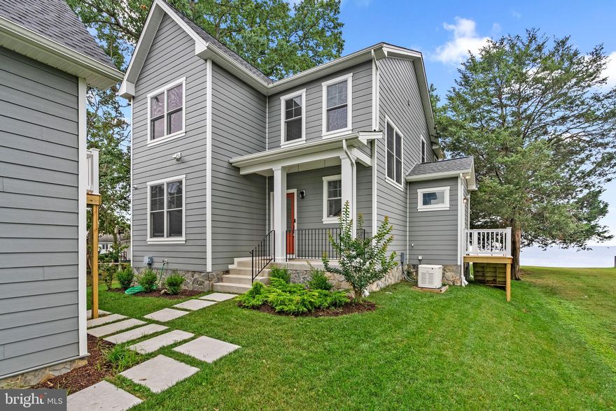 Experience breathtaking bay views from this stunning waterfront property newly built in 2022 in vibrant Owings Beach, complete with 3-4 bedrooms, 2 full baths, 1 half bath, 1,692 square feet, a 2-car garage, and a private pier for ultimate waterfront living. Stroll along the charming stepping stone pathway past the 2-car garage to this exquisite property that masterfully blends traditional and contemporary elements with simple yet elegant detailing. A cozy covered porch welcomes you into a main level bathed in natural light, featuring picturesque views and stylish laminate floors throughout.

Step into a grand foyer that ushers you into a versatile office (or bedroom) with abundant storage, a convenient half bath, and an inviting open-concept layout featuring a chef’s kitchen, dining area, and family room. This space is highlighted by rustic exposed wood beams and a stunning wood-burning fireplace framed by dramatic floor-to-ceiling stone. The eat-in kitchen is a chef’s paradise, featuring sleek new appliances and custom finishes. Enjoy abundant cabinetry, a stunning mosaic tile backsplash, and an expansive island breakfast bar. With stainless steel appliances, elegant pendant lighting, a gas range, and a walk-in pantry or mudroom, this kitchen is both functional and stylish. The adjacent dining room, complete with a statement chandelier and panoramic water views, offers seamless outdoor access for a peak dining experience.

Indulge in breathtaking sunrise views over the Bay from the opulent owner’s suite, complete with a spacious walk-in closet, charming exposed beams, and a private full bathroom showcasing dual vanities and an oversized glass-enclosed shower with stunning tiling and built-in shelves. The upper level also features a convenient laundry room and two additional bedrooms, each with access to a beautifully appointed full bathroom with dual vanities. This property also boasts an unfinished loft space above the garage, brimming with endless potential for customization.

Embrace the ultimate waterfront lifestyle in the expansive backyard, where lush green space and a charming bench invite you to soak in the serene views. The recently built pier provides easy access to water activities like jet skiing, fishing, crabbing, and more right from your own private oasis. Owings Beach offers a serene waterfront lifestyle with amenities such as marina access, parks, local dining, and community events, all enhancing the relaxed, bayfront living experience.