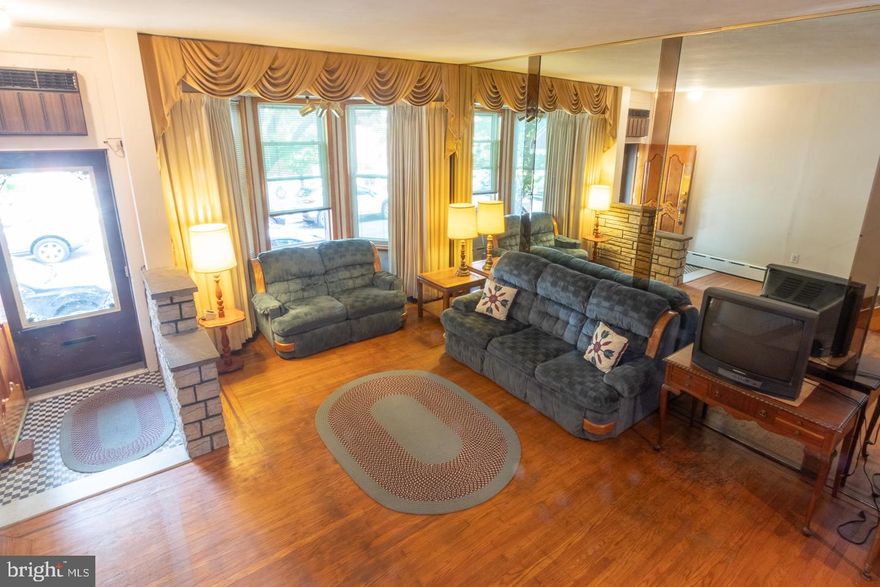 Welcome home to your very own "Miracle on South 13th Street"! Located on one of the most sought after blocks in East Passyunk Crossing this home has been loved and cared for by one family for almost 30 years and now eagerly awaits to share its love anew. This beautiful tree lined block known for its festive holiday displays and close knit community sets the perfect back drop as we escalate up the front steps and into this classic South Philly gem. Boasting over 2000 square feet of finished living space, you immediately feel the magnitude of this home as you enter into the comfort of its grand living room ornamented by its original hardwood flooring with custom inlays, large bay windows, floor to ceiling mirrored accent wall, and a beautifully rustic stone facade gas fireplace which serves as a quaint buffer before entering into the formal dining room perfect for hosting friends and family for all occasions. Continuing through the trellised entrance into the full eat in kitchen in the rear of the house you find the ample spaciousness of this home seems to be never ending. This section houses a large informal dining area before entering into the actual kitchen which features a counter peninsula stove top, a double oven, endless cabinet and counter space, as well as a separate drinking water tap with an under sink reverse osmosis water filtration system to go along with the whole house water softening system located in the basement. Exiting out the back door you find boundless potential for your very own urban oasis with one of the larger backyard living spaces you will find in the city. For your convenience the main level also provides the comfort of a half bath as well as plentiful closet space. Next we scale the home's unique custom staircase to the second floor which hosts three bedrooms as well as the main full bathroom. The master bedroom in the front of the house again features bay windows and a large closet with sliding mirrored doors. Both the middle and the rear bedrooms are very well sized creating quite comfortable living spaces.  Off of the rear bedroom and through the sliding glass door you will also find the added bonus of a second story roof patio adding to your outdoor paradise. On the third floor you will find another large front bedroom, a walk in closet, as well as the fifth bedroom which in the past has served as the perfect office space. The basement is partially finished in the front section, with a laundry room, half bath, and then a rear section which has been used as a wood shop/tool corral. Miracles like this don't happen everyday so don't miss your chance to see for yourself!