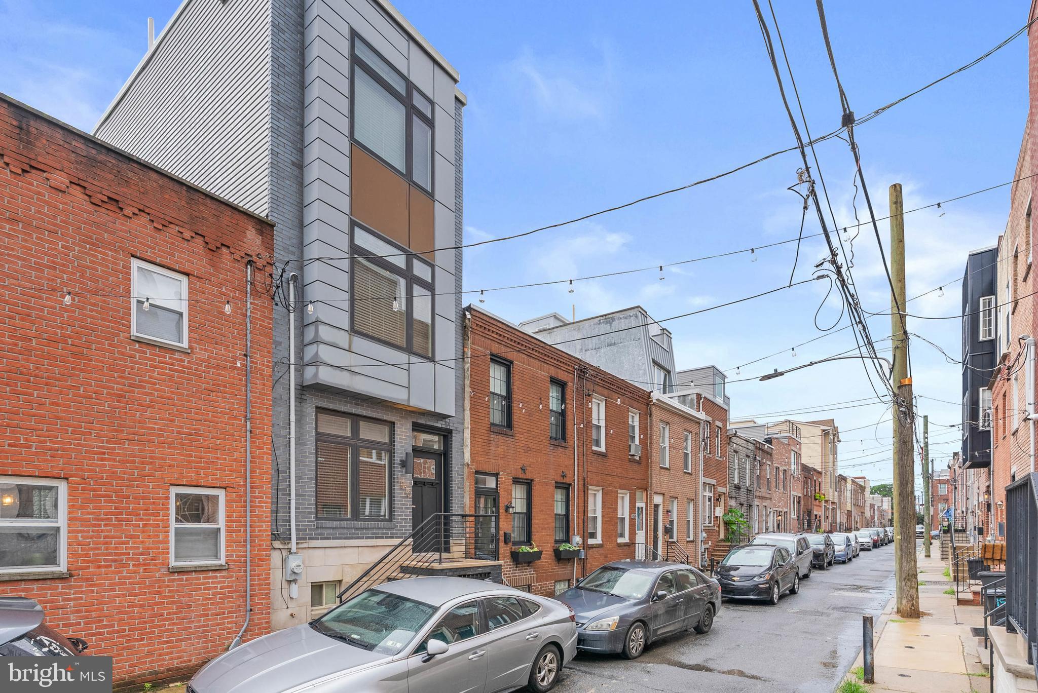 In Philly's sought-after Newbold neighborhood, a quiet, low-traffic block just off Broad St & Washington Ave plays host to 1510 Manton St. This newer construction home offers 3 bedrooms, 2.5 bathrooms, a finished basement, a private patio, and an expansive roof deck. This property has an estimated 2135 SF including the finished basement. Out front, you're greeted by a towering grey facade and an elevated entry. Inside, high ceilings and modern floors frame the bright, open, and airy main level. This functional layout allows plenty of space to create separate living and dining areas. Past a convenient storage closet, the gleaming kitchen features white shaker cabinetry, BRAND NEW stainless steel appliances, granite countertops, a tile backsplash, and extra room for an island cart with seating. Out back, the hidden patio acts as a peaceful retreat from the city's hustle, perfect for grilling, gardening, and dining under the stars. More living space is found in the finished basement, where you could create a cozy home theater or a fitness room. There's also a half bathroom and a guest bedroom. Up on the second level, two spacious bedrooms with bright windows, hardwood floors, ceiling fans, and generous closets sit on opposite ends. A full bathroom and a thoughtfully placed laundry closet are off the hall. The third level is dedicated to the primary suite. At the front is a sunlit bedroom with a walk-in closet. Down the hall, there's a spa-like full bathroom boasting a double vanity, a whirlpool tub, and a glass-enclosed, multi-jet rainfall shower. Topping off the home is a huge roof deck that's sure to be a popular spot for hosting friends and family while admiring the picturesque skyline views. In addition to everything inside, 1510 Manton St's prime Point Breeze location earns a Walk Score of 87! Popular restaurants, friendly cafes, and local businesses are all within a short stroll. Target, Sprouts Farmers Market, and Wine & Spirits are close, and neighboring East Passyunk has lots to explore. Plus, there's easy access to public transit, I-95, I-76, and University City. Schedule your tour today!