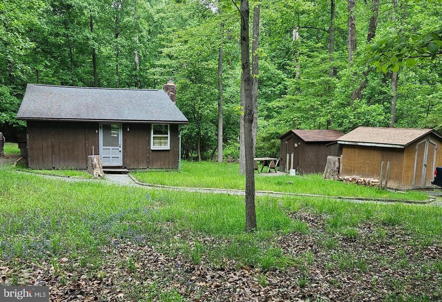 Your Cabin in the woods!   Close to Hiking Trails, Shenandoah River, Wineries, Breweries and more.  All paved access. NO HOA.  Xfinity Internet.  Lot size is approx but includes lots 183 & 184--NOT subdividable.  See DOCs for road maintenance fee,  water  and community info.  Good Condition but Sold AS-IS, How Is, Where Is.  This is the only photo available currently...Hope to have more by the end of next week