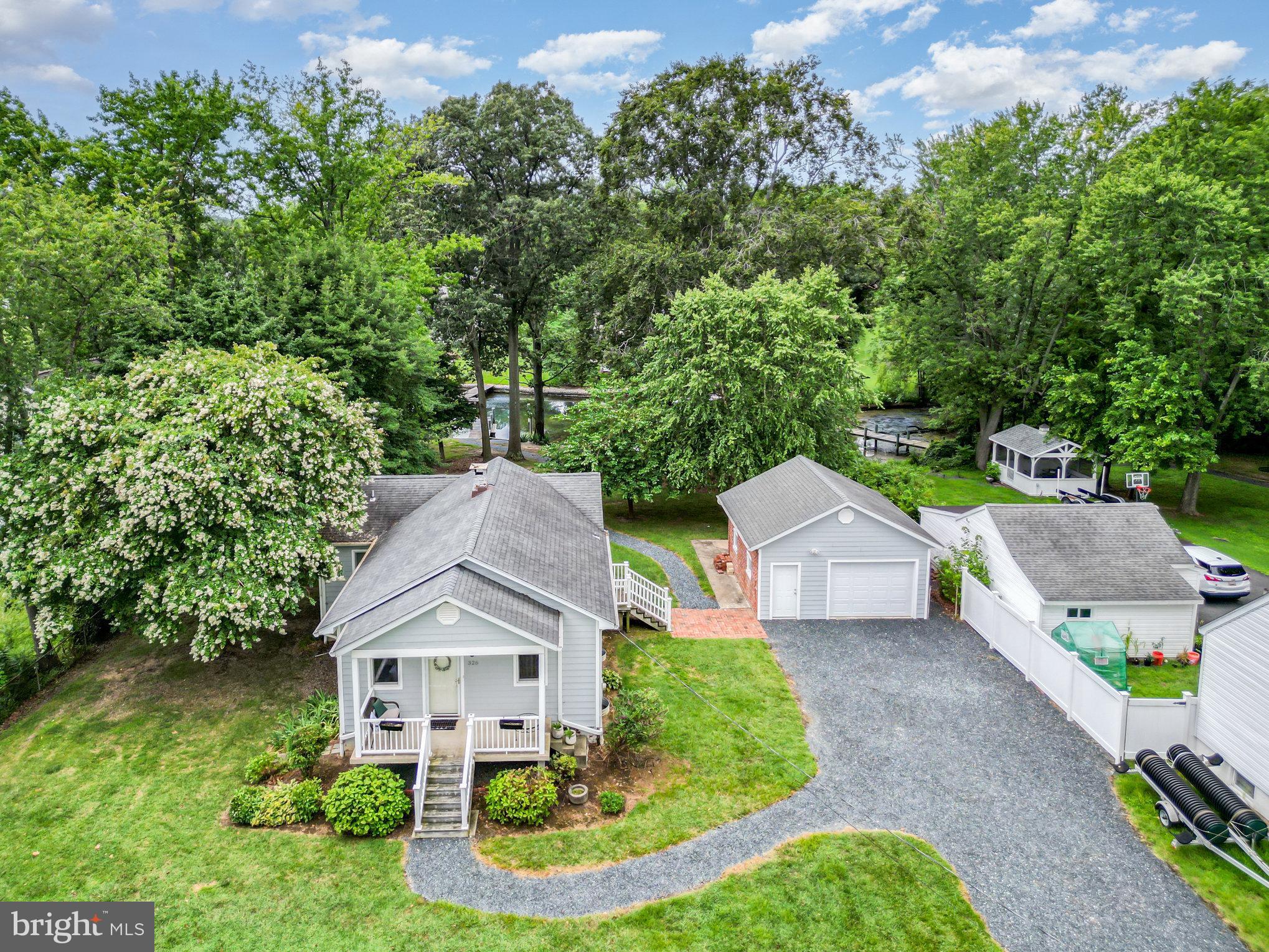 (Being Prepped for Professional Photos and Showings start Friday at 5pm) Idyllic Waterfront Cottage Retreat — Out of the Flood Zone! Discover your slice of Essex waterfront paradise with this charming, fully renovated waterfront cottage tucked away on picturesque Norman Creek, just minutes from the Middle River and a short jot to the open waters of the Chesapeake Bay and Eastern Shore. Perfectly positioned outside the flood zone, this home lets you enjoy waterfront living without all the stairs and elevation challenges. Set on an expansive 100 ft wide, deep lot framed by mature trees and lush shrubs, the grounds are designed for effortless entertaining and relaxed living — whether it’s children, pets, or guests running freely, or friends gathering around the private dock and bulkhead sitting area. The matching detached garage adds convenience and charm, while the gentle hillside slope guides you gracefully to the water’s edge. Originally reimagined in 2012, the interior and exterior updates included a new roof, siding, energy-efficient windows, cabinetry, appliances, updated wiring, plumbing, and HVAC systems — offering peace of mind and move-in-ready comfort. Live simply and beautifully, whether as your primary residence, weekend getaway, or a perfect safe harbor for your boat — just a quick cruise to the Chesapeake Bay and beyond. Enjoy easy access: only a few miles from Baltimore City and seconds off I-695 & Rt 702, connecting you effortlessly to points North, South, East & West. Embrace the best of waterfront lifestyle without compromise — stunning grounds, shade from mature trees, level lot, water access, and a lovingly redone interior ready to welcome family, friends, and unforgettable memories. The entire property is being sold as-is and the sale is to include the furniture, bedding, televisions, dishes, plates, flatware etc.