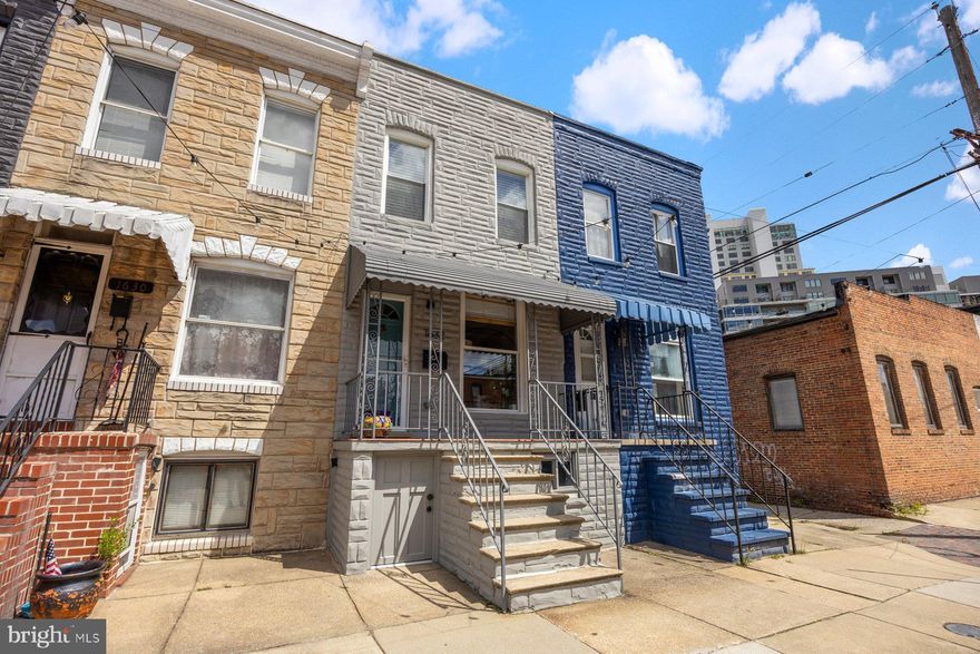 PORCH FRONT HOME LOCATED IN LOCUST POINT WITH 3 FINISHED LEVELS & AN ABUNDANCE OF UPDATES THROUGHOUT - this stylish home features an open floor plan with hardwood floors throughout, exposed brick, crown molding, new stair railing system and an updated kitchen with quartz countertops and ss appliances leading to rear paver stone patio.  The upper-level features two bedrooms and hallway bathroom and the completely renovated walk out basement offers flex space of a potential 3rd bedroom and brand-new full bathroom.  This one is a must see - centrally located in Locust Point makes walking to many neighborhood attractions a breeze!