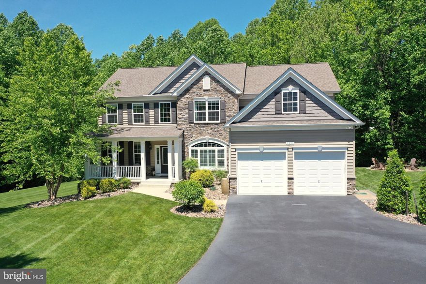 COMING SOON!  Welcome Home to QBHI's Aberdeen Model in the Simmons Ridge Community.   We personally invite all pre-qualified buyers to attend the grand opening (OPEN HOUSE) of this home to the market on 06/01/2024  (12:00 p.m.-3:00 p.m.) Everything about this home has been meticulously completed from its private setting and landscape to its finishes and interior design. The main level boasts an elegant two story foyer featuring gorgeous hardwood floors with the formal dining room and home office/study at either side. This home is perfect for relaxing and entertaining with the open floorplan featuring a family room with gas fireplace, mantel and marble surround,  recessed lighting, and beautiful private views out the windows. The spacious Gourmet Kitchen boasts under cabinet lighting, center island, GE Slate finish smudge proof appliances, upgraded  42" cabinetry package with glaze and crown molding, granite counter tops, gas cooktop, Double wall ovens, built-in microwave, farmhouse sink, coffee bar, pantry, ample table space, and a walk-out to rear deck at rear of kitchen and walk out to large screened in porch from side of kitchen. The dual entry staircase leads to the upper level where you will find 4 large bedrooms to include the owner's suite featuring it's own private screened porch,  a tray ceiling, an extended walk in closet, and the owner's luxury bath with ceramic tile, dual vanity sinks with granite, free standing oval tub and walk-in grand shower with a built in bench. The three additional bedrooms are spacious and share a large hall bath with dual sink vanity with private bath. The laundry room is conveniently located  next to the bedrooms. The lower level is complete with a large recreation room with kitchenette and bar with access to fenced in backyard. There is also a guest room/flex room with a separate full bath and a generous size storage room/workshop for all the extras.  This home's many upgrades include crown molding throughout, upgraded doors and fixtures, all bedrooms have ceiling fans with lights, hardwood floors on main level and stairs, top-of-the line kitchen cabinetry and appliances,  bathrooms with ceramic tile, upgraded lighting throughout, dual zoned heat with programmable thermostat, surround sound prewire, WIFI connected garage openers with remotes, newly epoxied flooring in garage with added storage space, mudroom off garage with built-in coat and shoe storage, complete lawn irrigation system, partially fenced rear yard, flood lights, professionally built fire pit with pavers, shed, hearty landscape, both screened porches include roller shades for privacy, and paved driveway for ample additional parking. The owners are conveying the gazebo on deck with ceiling fan, the refrigerator, bar and stools in lower level, and rack of firewood for the firepit, This property is maintained with a frontline termite treatment plan (never any issues), and septic was last pumped in November 2023.  School attendance is Huntingtown High, Plum Point Middle, and Calvert Elementary. The community is centrally located in Calvert County and near to the local waterways, beaches, parks, restaurants, shopping, museums, theaters, concert venues at Calvert Marine Museum, and so much more. There's no mistake you found this gem, but be pro-active and get ready because this one won't last!
