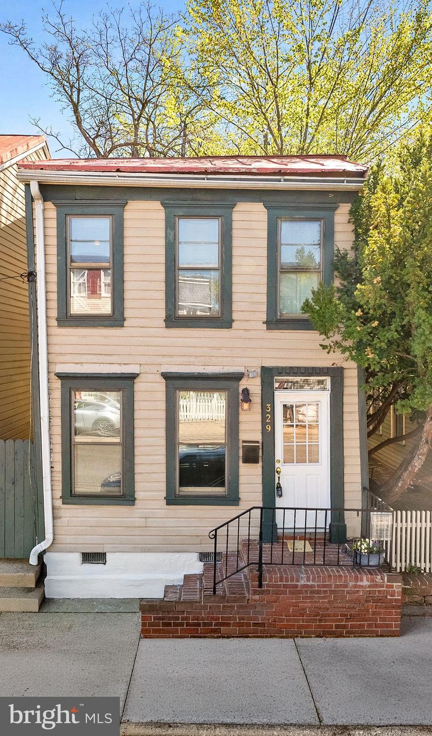 Historic Character, Thoughtful Updates, and Opportunity,

Located between Queen and Princess in the heart of Alexandria, this detached Old Town home offers a rare combination of authentic history, key updates, and future potential.

Spanning approximately 1,400+ square feet, the home features 3 bedrooms and 2.5 baths, including a primary suite with en suite bath — a unique offering for this location.

The front portion of the home dates to the post–Civil War era (circa 1870–1880), with expansions in the late 19th century and again in the early 20th century. The result is a classic “shotgun-style” layout, with open living and dining spaces leading to the kitchen and rear utility areas.

Historic character is evident throughout. The living room is anchored by a custom brick feature wall built with reclaimed 19th-century brick sourced from a Washington, DC building of the same era. At its center is a Vermont Castings Dutchwest Federal Convection Heater (Model 2460), a high-efficiency cast iron wood-burning stove known for its strong heat output and classic styling.

The kitchen was fully remodeled in 2026, including new subflooring and hickory flooring. A walk-in pantry just off the dining area provides rare and highly functional storage.

Additional updates include a new HVAC system (July 2025) and a durable metal roof.

The home offers:

    •Open living and dining rooms,
    •Rear kitchen with direct backyard access,
    •Laundry area with adjacent half bath,
   
The fenced backyard is notably spacious for Old Town and features a bluestone slate patio (approximately 15’ square), creating an ideal setting for outdoor dining and entertaining. Mature tree canopy provides shade and privacy.

Off-street parking for two vehicles is available via the rear alley.

The property has also been the subject of archaeological study, reflecting the layered history of the site and its evolution over time.

Ideally located between both Braddock Road and King Street Metro stations, this home offers exceptional access to transit, dining, and shopping.

This property presents a compelling opportunity to own a detached historic home with character, recent system updates, and the ability to further enhance over time.

Sold as-is.