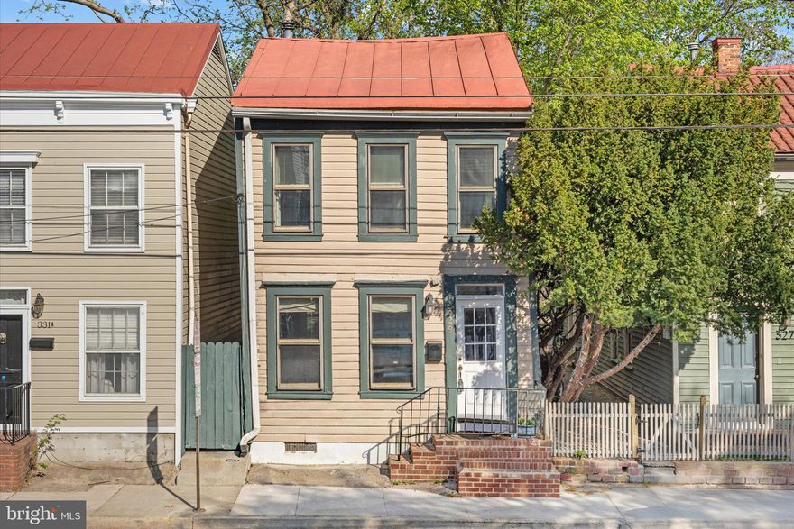 Historic Character, Thoughtful Updates, and Exceptional Opportunity.

Located between Queen and Princess in the heart of Old Town Alexandria, this detached home offers a rare combination of authentic history, key updates, and incredible potential for the next owner to make it their own.

Spanning approximately 1,400+ taxable square feet, the home features 3 bedrooms and 2.5 baths, including a primary suite with an en suite bath--a unique offering for this location. Original pine hardwood floors lie beneath the carpet on the main and upper levels, offering an exciting opportunity to restore and enhance the home’s historic charm.

The front portion of the home dates to the post–Civil War era (circa 1870–1880), with expansions in the late 19th and early 20th centuries, resulting in a classic shotgun-style layout with open living and dining spaces that lead into the kitchen and rear utility areas.

Historic character is evident throughout, including charming built-ins that add both functionality and timeless appeal. The living room is anchored by a custom brick feature wall built with reclaimed 19th-century brick sourced from a Washington, DC building of the same era. At its center is a Vermont Castings Dutchwest Federal Convection Heater (Model 2460), a high-efficiency cast iron wood-burning stove known for its strong heat output and classic styling. During the colder months, the stove serves as a powerful supplemental heat source, helping reduce overall energy usage while creating a warm and inviting atmosphere.

The kitchen was fully remodeled in 2026, including new subflooring and hickory flooring, and the home has been further updated with a new HVAC system installed in July 2025 along with a durable metal roof.

The main level offers open living and dining areas that flow into a rear kitchen with direct access to the backyard, as well as a laundry area with an adjacent half bath for added convenience.

The fenced backyard is notably spacious for Old Town and features a bluestone patio, creating an ideal setting for outdoor living, dining, and entertaining. With rare rear alley access and two off-street parking spaces, the lot opens the door to a variety of possibilities -- whether expanding the home, enhancing the outdoor space, or exploring future options such as a garage with additional living space above (buyer to verify).

Bring your vision and transform this historic property into its full potential. Opportunities like this — a detached home with land, parking, and flexibility--are increasingly rare in Old Town.

Enjoy the best of Old Town living with close proximity to charming boutiques, award-winning restaurants, waterfront parks, and year-round community events, all just minutes from your doorstep. Ideally located near both Braddock Road and King Street Metro stations, the home offers exceptional access to public transit and is just a short commute into Washington, DC, making it an ideal choice for those seeking both historic charm and city convenience.

The listing price reflects the home’s current condition and presents a compelling opportunity for customization and long-term value.