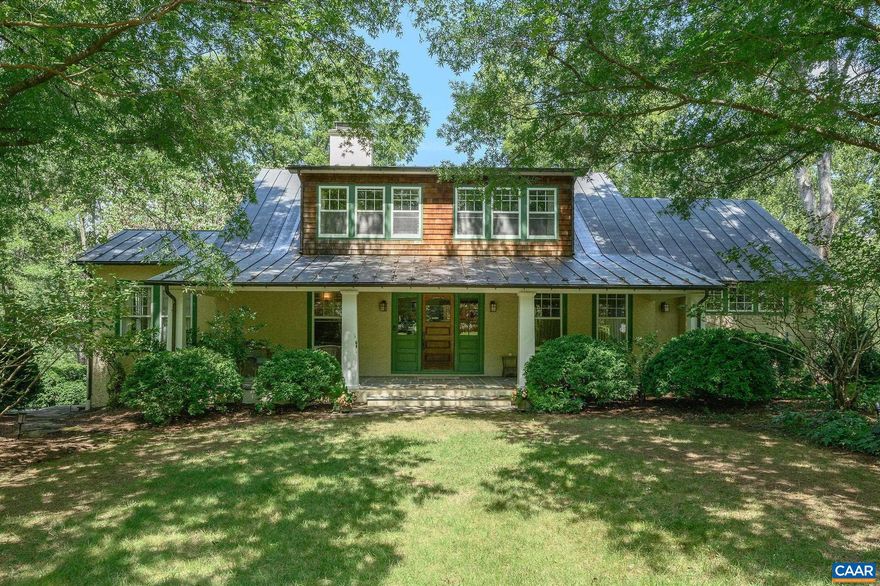 Wildwood is an exquisite example of an Arts and Craft Home maintaining the integrity of the period with 21st century improvements and additions. Built in 1917 with extensive oak woodwork defined by its emphasis on handcrafted simplicity, quality, and harmony with nature. The oak, quartersawn to highlight the straight grain, is used functionally and decoratively throughout the interior. The Built-in cabinetry highlights the joinery skills of the Arts and Crafts movement. A gracious entry opens to the living room with tile fireplace and sunlit dining room creating a flowing space. A dream kitchen and breakfast area are timeless. The Library/den has floor to ceiling bookcases and Blue Ridge Views. First Floor living is possible with the seamless addition of a first floor primary suite with private porch. The main house has 2 additional bedrooms & a 2nd floor primary bedroom, with a total of 3.5 baths. Delightful guest house/studio 2 full baths &versatile floorplan. The 5.6 Magical Acres have multiple porches, terraces, mahogany deck, stone walkways and walls, pool and pool house. There is a  separate Garage and Garden shed, copper roof, generator, solar panels. Only minutes to Barracks Road and town. Past Foxfield on the right.,Oak Cabinets,Soapstone Counter,Wood Counter