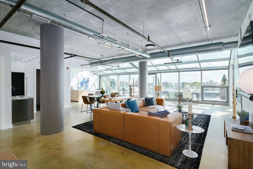 Settle into this absolutely stunning 2 bedroom, 2 bathroom Center City penthouse situated along the legendary Avenue of the Arts. The prime location promises potential for endless exploration of Center City culture, dining and shopping but you may never want to leave home. An oasis of luxury and effortless convenience, this beauty with soaring 10ft ceilings and full FLOOR TO CEILING WINDOWS is a space of generous light, industrial exposed concrete, and modern lines that offer a unique balance. An open outdoor space for basking in a Philadelphia sun is at your beck and call. The penthouse boasts the exquisite craftsmanship of Porcelanosa custom cabinets, Sonneman Modern Lighting fixtures, and a CLEARion double side fireplace. The kitchen comes to life for your inner chef with a Calacatta marble waterfall, state of the art Bosch Range and refrigerator, and a THOR 24-inch freestanding Dual Zone Wine Cooler, promising the potential to create boundless moments.  A personal café is made available by a built in Bosch espresso machine. Brilliant mornings and deep dark nights are yours by way of the spacious master bedroom and the infinite wall of windows. This huge private oasis is one you’ll never want to leave with stunning views and endless comfort. The master bathroom includes double custom vanities, Porcelanosa floors, a glass walk-in shower and Brizo plumbing hardware finishes. On the other end of the unit is the graciously sized second bedroom plus full guest bathroom with Porcelanosa custom vanity and frameless glass door enclosed shower. The large laundry room with custom cabinets and a utility sink offers optimal function and form. The penthouse comes with two designated parking spaces that are monitored 24 hours. A Sleek and contemporary Lobby with 24hr concierge, walking distance to restaurants, boutiques, coffee shops, and easily accessible public transportation.