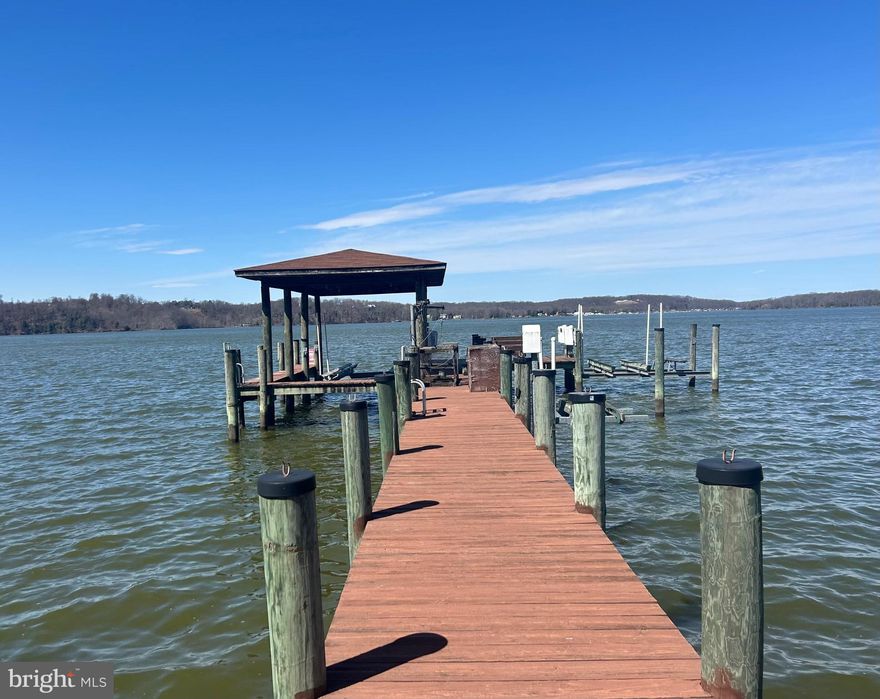 RARE opportunity to own nearly 4 acres of mostly cleared and slightly elevated waterfront land in Stafford, VA. With stunning sunset views and natural elevation, this property offers the perfect setting for your future dream home or private retreat with potential for panoramic water views. Features include a covered boat dock with two boat lifts and a jet ski lift, plus existing septic, well, and electricity already on site— all conveyed as-is, with conditions unknown. Bonus structures include a pole barn, camper, and a few other small structures — all conveyed as-is, with conditions unknown. Don’t miss your chance to enjoy peace, privacy, and direct water access on this truly special piece of land.