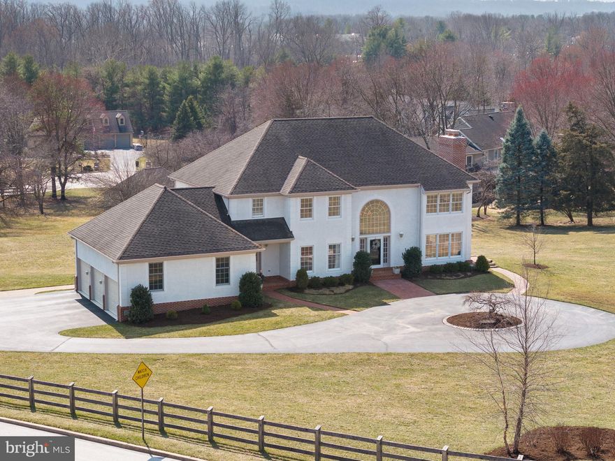 This beautiful, sun-drenched home sits on a stunning 2-acre lot, just steps from Valley Forge Park, offering an open floor plan with 9' ceilings on the main floor. Set at the base of Mt. Joy in the highly regarded Tredyffrin Easttown School District, the home boasts breathtaking views from every window. This traditional property offers 4 bedrooms, 3 full baths, and 2 half baths, with over 5,500 sq ft of finished living space, including 4,300 sq ft on the first and second floors. The beautifully finished walkout/daylight lower level features a media room, full bath and great versatile space! The home also features a spacious 3-car oversized attached garage, plus a detached 2-car garage—perfect for car enthusiasts! The detached garage, which already has electricity and water, would also make an excellent pool house. The grand two-story entrance hallway leads to the fabulous family room, which features a vaulted ceiling, twin skylights,  door to the deck, a wet bar, and a striking fireplace with dramatic floor-to-ceiling custom stonework. On the left of the entry hall is the expansive formal dining room, complete with stylish wainscoting and chunky crown molding. To the right, you'll find the classic living room, featuring a gas fireplace with marble surround, crown molding, new wood floors, and a door to the side yard. The large private office offers new wood floors and a cozy window seat, perfect for reading while enjoying the beautiful views. The heart of the home is the spacious eat-in kitchen, which offers abundant cabinetry, granite countertops, a large center island that seats four, stainless steel appliances, a large dining area, and patio door to a newer oversized deck. A pleasant laundry room with cabinets, an exterior door, a laundry chute from the second floor, in addition to two powder rooms complete the first floor. A large second-floor hallway overlooks both the entrance hall and family room, leading to the primary suite. The suite includes a beautifully detailed gas fireplace, a tray ceiling, two walk-in closets, and a spacious primary bath with two white vanities, a frameless glass shower, a soaking tub, and a skylight that fills the space with natural light. Three additional bedrooms share a spacious hall bathroom with a double white vanity and a separate shower/lavatory area. The beautifully finished walkout lower level is a versatile space that features a large patio door to a paver patio, a newly renovated full bath, a media room with a projection TV, and plenty of space for a playroom, gym, or craft area—the possibilities are endless! The grounds of the home are truly spectacular. The deep, fully fenced yard includes over $40,000 in new plantings, including evergreens along the property line, and a detached 2-car garage with plumbing and electricity. The oversized deck is the perfect spot for relaxing, entertaining, dining al fresco, or simply enjoying the views. Additional features include a new septic system, public water, two HVAC systems, and a  partial house generator. Recent improvements include $40,000 in new landscaping, fenced-in yard, resurfacing of the driveway, a remodeled lower-level bath, replacement of the second-floor HVAC, rebuilding chimneys with a brick façade, and the replacement of all septic system mechanics. This is a rare opportunity to own a tastefully upgraded home in a spectacular setting within the top-ranked Tredyffrin Easttown School District. The location is ideal—less than a minute from Valley Forge National Park, 5 minutes from Trader Joe's and Gateway Shopping Center, less than 10 minutes from Lifetime Fitness and King of Prussia Town Center, and close to the great restaurants of the Main Line. This is a fantastic home on a great lot in a fantastic location. A must-see!
