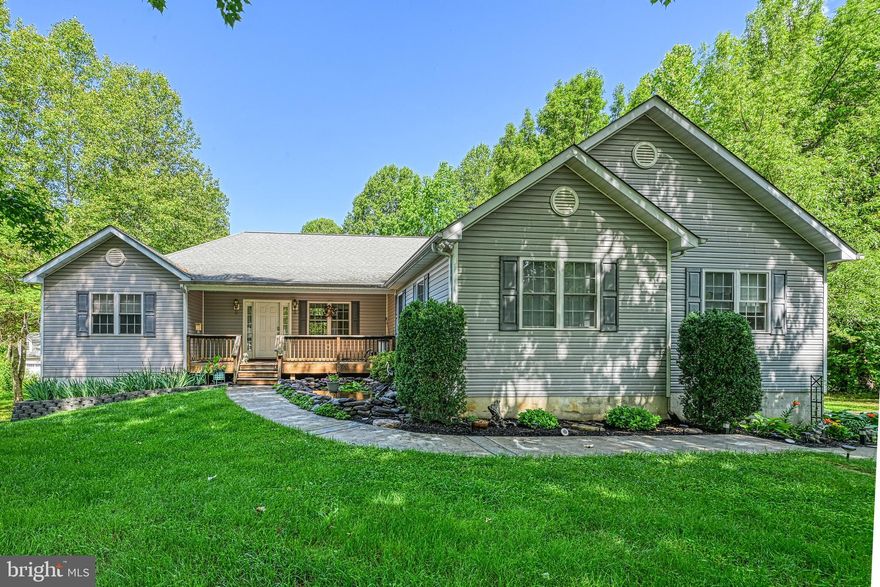 STUNNING WATER VIEW HOME WITH DEEDED BOAT SLIP--This beautifully maintained 5-6 bedroom (3-Br Drainfield), 3-bath home, almost 4,800 Sq Ft, offers breathtaking Fall/Winter Lake views and comes with a deeded boat slip just a short distance away and a gorgeous Koi Pond in front of the house.  NO HOA, NO WATER ISSUES, AND SELLER OFFERING A HOME WARRANTY.  With its spacious and inviting layout, this home is perfect for year-round living, a relaxing vacation retreat, or multiple other uses.  On the main level, you'll find a bright and airy dining area, a lovely living room with a gas fireplace, and a charming breakfast or sitting room—ideal for unwinding while taking in the lake views. The gourmet kitchen features granite countertops, ample cabinet space, newer appliances, and picturesque water views. The formal dining room adds a touch of elegance and is open to the main level, while the separate laundry room, equipped with a utility sink, provides added convenience.  The primary suite on the main level is a private retreat with two walk-in closets and a luxurious ensuite bath. The walkout basement is mostly finished and includes two to three generously sized bedrooms, each with a closet and a window, a full bath, and a versatile bonus room with a pellet stove to keep the house warm and electric bills low in the winter!  The unfinished area of the Lower Level features a rough-in for an additional kitchen and bath, offering endless possibilities, such as an In-Law Suite, extra living space for large families and friends, a Media Room, home gym, workshop, and storage. Outside, the paved driveway leads to an oversized two-and-a-half-car garage, providing ample parking and storage space. The level yard makes outdoor maintenance a breeze.  Enjoy the best lake living with easy access to your deeded boat slip in the nearby common area where the water is crystal clear! This prime location is just minutes from Pleasant's Landing Marina and El Patron Restaurant. With convenient access to Route 601 and I-95, this home offers a rare find for those looking to commute to Northern Virginia. Don't miss out—schedule your showing today!