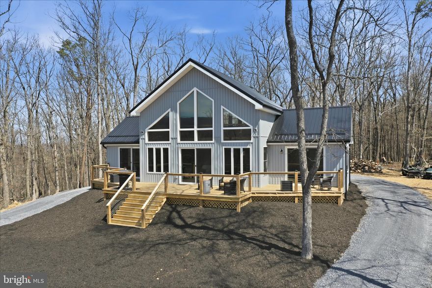 Imagine waking up every morning to the views this home provides! Take in miles of uninterrupted mountain views from the expansive deck, where mornings begin with quiet light and evenings gather around the firepit under open skies. Set on over 2 acres, 432 Lost Point Lane in Berkeley Springs, West Virginia offers a setting that feels private and connected to the landscape, with panoramic vistas that are rarely found. Wanting a true West Virginia Mountain getaway that is newly constructed with upgrades to match? Keep reading!  Built in 2025, this custom home blends craftsmanship with thoughtful design across approximately 1,900 square feet. Wood flooring runs throughout, complemented by custom tiled showers and a well-appointed kitchen featuring high-end appliances, including an adjustable waterfall faucet at the sink with all the bells and whistles. Built with top-tier insulation, the home supports comfort and efficiency in every season. A standout feature is its ADA-compatible design—an uncommon find in today’s market—featuring wider doorways, lever-style handles, tilted mirrors, and a roll-in tiled shower, all seamlessly integrated into the home’s layout. Two main-level primary suites each include full baths, offering a balanced and functional design. An additional full bath in the loft provides added flexibility. There is no part of this home that has not captured the views! When you close the doors to the bedrooms, you are still blessed with amazing views and access to the massive front deck . The home is fully furnished, creating a turnkey opportunity from day one. Just move right in! Enjoy community water access just moments from your doorstep—perfect for fishing, kayaking, and relaxing by the water. Located less than two miles from Cacapon Resort State Park, with easy access just 6 miles to the Virginia line and a short drive to historic Berkeley Springs, this location offers both recreation and convenience.
. Every detail supports a lifestyle centered on ease, comfort, and the surrounding view. Book a showing today! This one is a rare find in this market and is ready for you to call home!