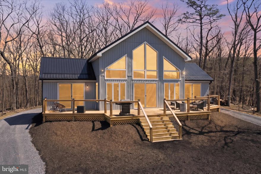 Imagine waking up every morning to the views this home provides! Take in miles of uninterrupted mountain views from the expansive deck, where mornings begin with quiet light and evenings gather around the firepit under open skies. Set on over 2 acres, 432 Lost Point Lane in Berkeley Springs, West Virginia offers a setting that feels private and connected to the landscape, with panoramic vistas that are rarely found. Wanting a true West Virginia Mountain getaway that is newly constructed with upgrades to match? Keep reading!  Built in 2025, this custom home blends craftsmanship with thoughtful design across approximately 1,900 square feet. Wood flooring runs throughout, complemented by custom tiled showers and a well-appointed kitchen featuring high-end appliances, including an adjustable waterfall faucet at the sink with all the bells and whistles. Built with top-tier insulation, the home supports comfort and efficiency in every season. A standout feature is its ADA-compatible design—an uncommon find in today’s market—featuring wider doorways, lever-style handles, tilted mirrors, and a roll-in tiled shower, all seamlessly integrated into the home’s layout. Two main-level primary suites each include full baths, offering a balanced and functional design. An additional full bath in the loft provides added flexibility. There is no part of this home that has not captured the views! When you close the doors to the bedrooms, you are still blessed with amazing views and access to the massive front deck . The home is fully furnished, creating a turnkey opportunity from day one. Just move right in! Enjoy community water access just moments from your doorstep—perfect for fishing, kayaking, and relaxing by the water. Located less than two miles from Cacapon Resort State Park, with easy access just 6 miles to the Virginia line and a short drive to historic Berkeley Springs, this location offers both recreation and convenience.
. Every detail supports a lifestyle centered on ease, comfort, and the surrounding view. Book a showing today! This one is a rare find in this market and is ready for you to call home!