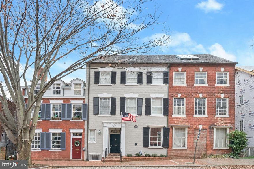 Welcome to 116 Prince Street, an exceptional Federal-style brick townhouse on iconic Captain’s Row in the heart of Old Town Alexandria. Built around 1770 and rich in history, this home has been carefully renovated to honor its architectural legacy while seamlessly incorporating sophisticated modern enhancements.

Original heart pine plank floors and period moldings remain intact, complementing European-inspired upgrades throughout. The home offers five bedrooms, three and one-half baths, and three fireplaces across approximately 3800 square feet of finished living space. 

A gracious entry foyer opens to the formal dining room with custom built-in shelves. Also on the main level, the chef's kitchen is open to an inviting living room anchored by a wood-burning fireplace and French doors that lead to a picturesque slate patio. Beyond, a terraced, walled garden creates a private outdoor retreat featuring a gas firepit, hot tub, and dedicated entertaining spaces ideal for year-round enjoyment.

The second level features a spacious family room complete with a fireplace and a private deck overlooking the garden below, as well as a primary suite with en-suite bath and two walk-in closets. The second level includes three generously sized bedrooms and full bath #2. The top floor has been thoughtfully finished as an expansive play room, private office, or optional bedroom #5, offering charming views of Old Town rooftops and glimpses of the Potomac River.

The moody lower level includes a cozy recreation room with bar and wine wall, sitting area, spa-like bath with soaking tub, and laundry room —perfect for hosting or relaxing. Located just one block from King Street, Captain’s Row is one of only two historic cobblestone streets in Old Town, offering an unmatched blend of charm, prestige, and walkable convenience. Convenient off-street garage parking for one car is currently rented.