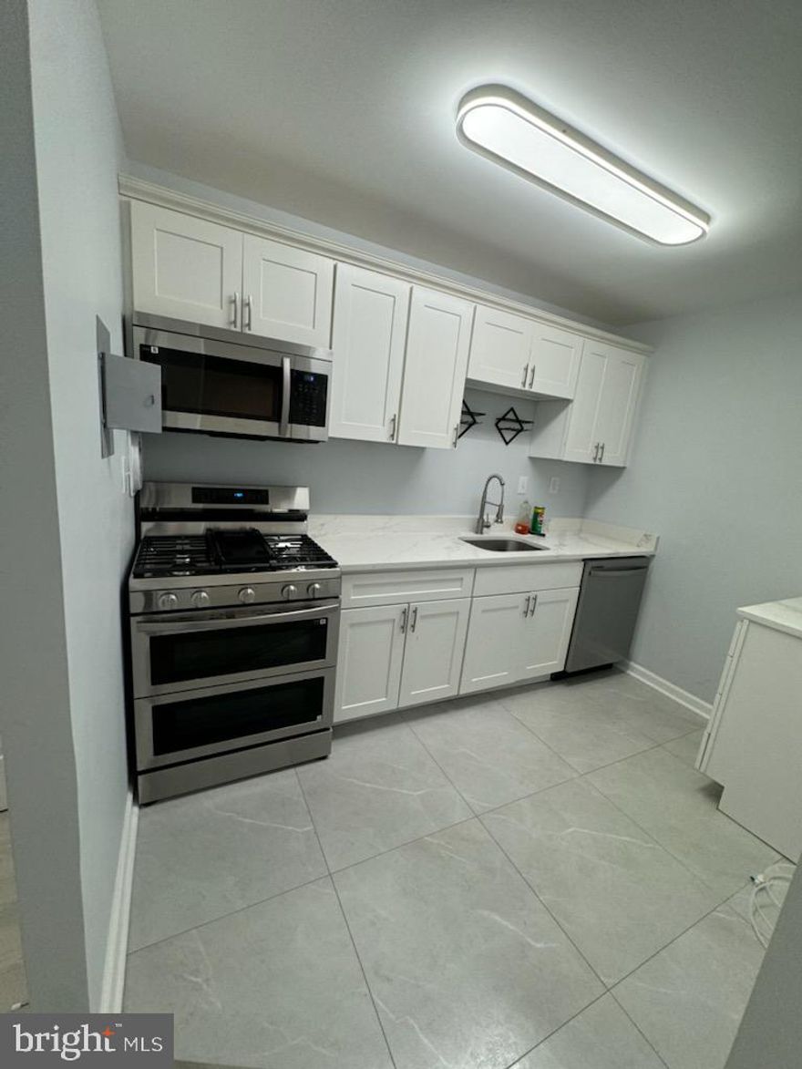 Almost new!! Beautiful ground floor unit _no steps! Huge slider door lets in plenty of sunshine.  Nice quiet street. Close to AMTRAK ; METRO rail; bus routes and shopping.  This bright and open floor plan offers a lovely expansive living room with easy  CLEAN NEW VINYL FLOORS floors throughout.   New double pane windows to view front  yard. The separate  dining area is large with wainscoting /chair rail and new light fixture. Gas heat keeps condo nice and warm, and CAC keeps cool.   Home boasts a  large GALLEY  kitchen FULLY UPDATED!  New gas DOUBLE OVEN for cooking enthusiasts. Kitchen has beautiful white quartz counters, new  stainless steel dishwasher and black stainless steel refrigerator with icemaker.   New low maintenance waterproof vinyl flooring, new light fixtures, new sink and new garbage disposal.  Sturdy upscale  cabinets with new stainless handles and new wine rack above quartz countertop. Crown molding accents kitchen cabinets.   Fully updated  bath with new flooring, new custom tiling in tub surround , new vanity, upscaled light fixture and new accessories,  new faucet and new toilets -----will yield years of low maintenance usage.  The large master has large closets with new doors new double pane window with screen. Plenty of light and windows throughout!  Entire home freshly painted neutral colors. All wooden doors were updated with modern 6 panel doors and new doorknobs.
Plenty of parking in quiet parking lot.  New exterior light fixtures on curb to see late at night. Low monthly condo fee, great price - won't last.  Agents Show!!! You wont be disappointed!