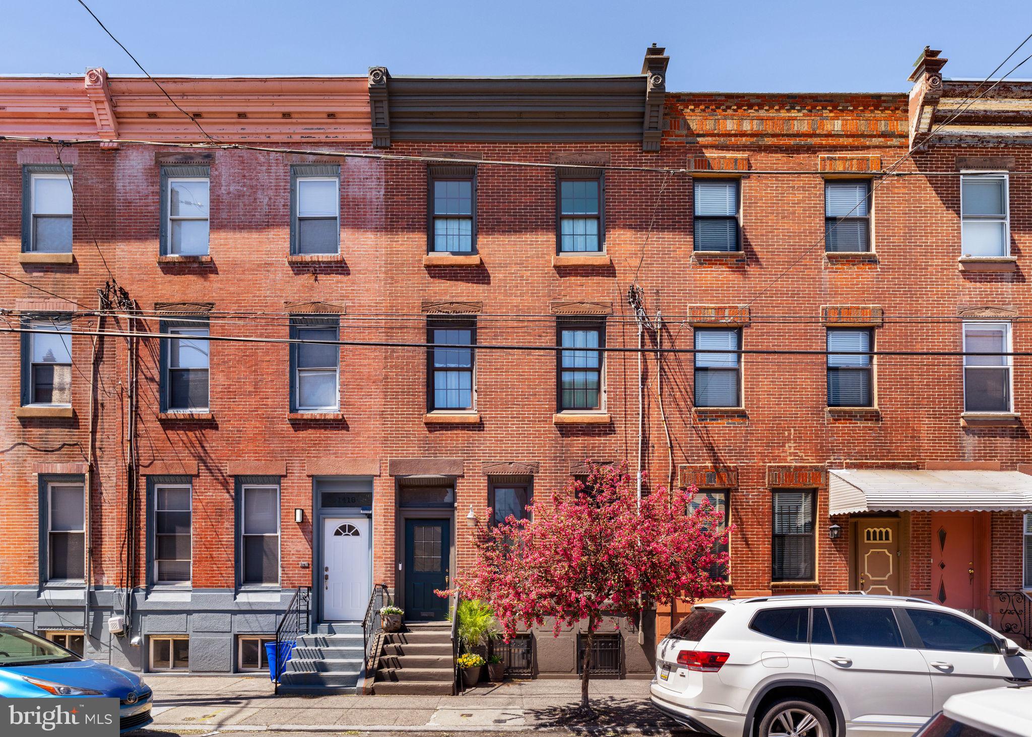 They don’t make them like this anymore! This East Passyunk stunner has all the charming original details of an older home with all the beautiful renovations and smart updates in the places you want them. Crystal doorknobs and deep moldings with a new kitchen and baths? You’re in the right place. Enter through the original tiled vestibule and into an expansive first floor with soaring ceilings. The formal living room is large enough for both lounging and play, and the centerpiece is a gorgeous mantle and reclaimed vintage light fixture. The dining space is large enough for dinner parties and holiday gatherings and opens to the newly renovated kitchen. White shaker cabinets pair with herringbone tile floors, vintage pendant lights, and an island topped with a custom counter by Provenance. Other upgrades you’ll rarely find in a South Philly home include a full size walk in pantry, KitchenAid appliances, and a 36” Verona range from Italy. And the first floor half bath? It’s tucked away on the hall behind a mirrored pocket door, but not overlooked when it comes to its gorgeous design. The second floor features the primary bedroom with french door entry, enormous walk in closet, and en suite bath. A dual vanity and a glass enclosed shower feature timeless finishes. Rounding out the second floor are a second generously sized bedroom, office nook with built in shelving, and a hall bath that would rival a primary bath in any other home - it has a deep tub, marble tile, and a linen closet. The third floor features a suite with a bedroom, bathroom with shower, and a living area with kitchenette. The basement is home to the laundry and ample storage space. Aside from beautiful renovations, a ductless mini-split system has been added for efficient zoned air conditioning. East Passyunk neighborhood offers a plethora of highly rated dining and shopping options, as well as conveniences like grocery and pharmacy and close proximity to the Broad Street Line. Favorites include Dough Head Pizza, Milk Jawn, Superette, The Dutch, Barcelona, Stateside, and many more. The home is also uniquely positioned on 9th St, just a few blocks directly south of the Italian Market for open air shopping and wonderful specialty culinary shops.