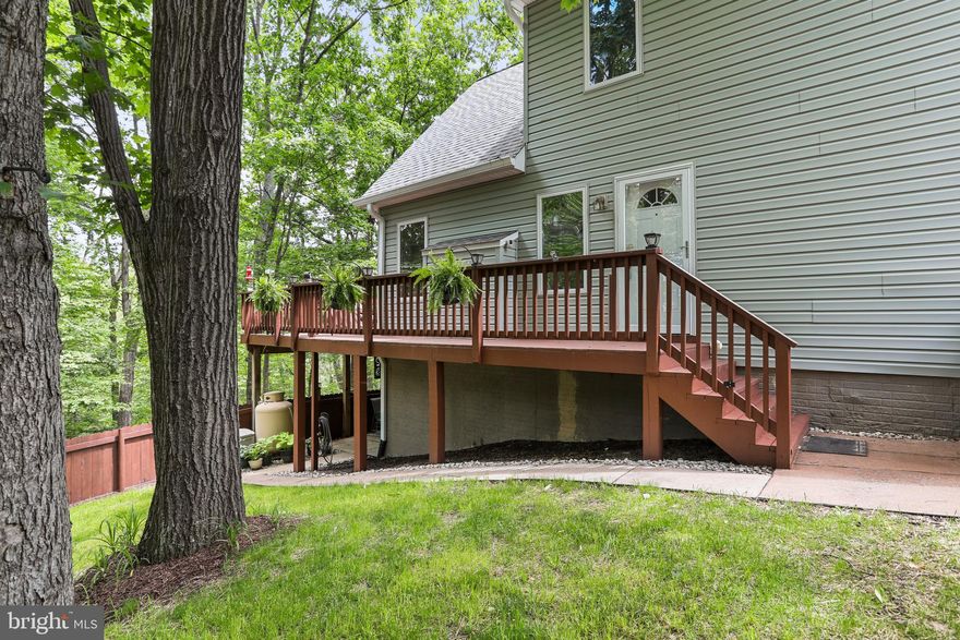 This well-maintained Chalet-style home is nestled on a wooded 1.01-acre homesite in The Woods, offering privacy, peace, and room to grow. Recent updates include a new roof and a freshly restained 33.5 x 10 open deck, perfect for enjoying the outdoors with friends and family.

Inside, the main living area features cathedral ceilings, a fixed glass window wall, and a gas fireplace for cozy evenings. Wood laminate flooring flows through the living room, dining area, and entry foyer. Two sliding glass doors open to the expansive deck with tranquil wooded views.

The home offers 3 bedrooms, 2 full baths, and an open loft—ideal for a home office, den, or potential 4th bedroom. The spacious primary suite includes a large walk-in closet, garden tub, double bowl vanity, and separate shower.

The unfinished walk-out lower level has rough-in plumbing for a future bathroom and offers endless possibilities for added living space. Additional features include a concrete patio, fenced-in yard, and low-maintenance vinyl siding.

A Class A membership is available with a one-time $3,150 initiation fee, granting access to the community’s amenities including golf, pools, tennis, and more.