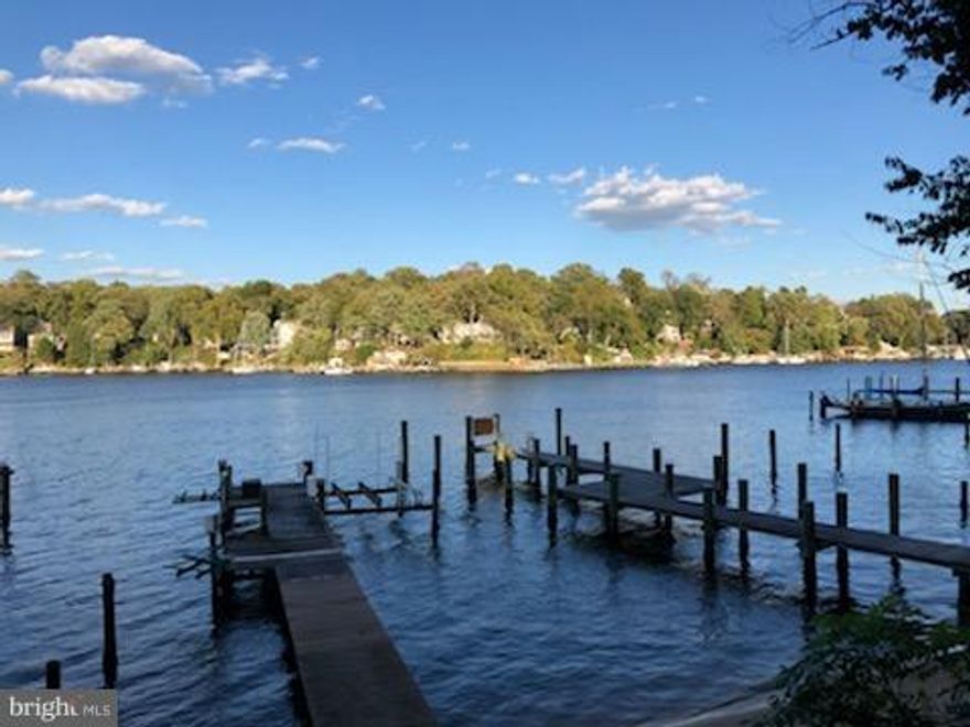 Great Price! Gorgeous Waterfront home w/ 11' water depth on the Severn River w/ Panoramic views. Two Story Sun filled Great room w/ stone gas FP. Gourmet Kitchen w/ Thermador Gas Cooktop*Granite Island*Breakfast Bar. Waterfront Main floor Master BD. Finished BSMT w/ In Law Suite/Kitchen/Exercise rm. .52 acre lushly landscaped w/ outside stone FP, Deck, SANDY BEACH, Pier,Boat Lift, 2 jet ski lifts!