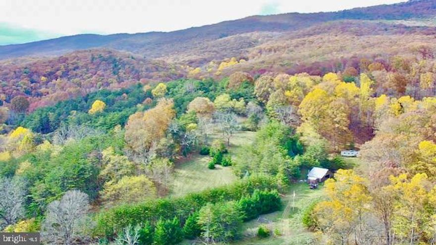 Perched on the mountain side over looking the majestic Smoke Hole Canyon located less than 3.5 miles from the trout filled South Branch River.  This 16.08 acre property has everything you need for the outdoor enthusiast.  Featuring a 23ft.X45ft pole barn with concrete floor, electric and could easily be converted into a cabin.  Also features a Kioti DK55C 55HP four wheel drive tractor with cab, heating, air-conditioning and front bucket.  Attachments for the tractor include 5ft cycle bar mower, 7ft Box Blade, 6ft King Bush Hog, 6ft finishing mower and 16ft goose neck trailer with a 4ft dove tail.  The property also features a well, septic and bathhouse in good condition.  This property has everything you want along with several potential building sites  and borders the Mon National Forest on two sides!  Don't let this one of kind property pass you by.  Call Now This Property Won't Last Long!