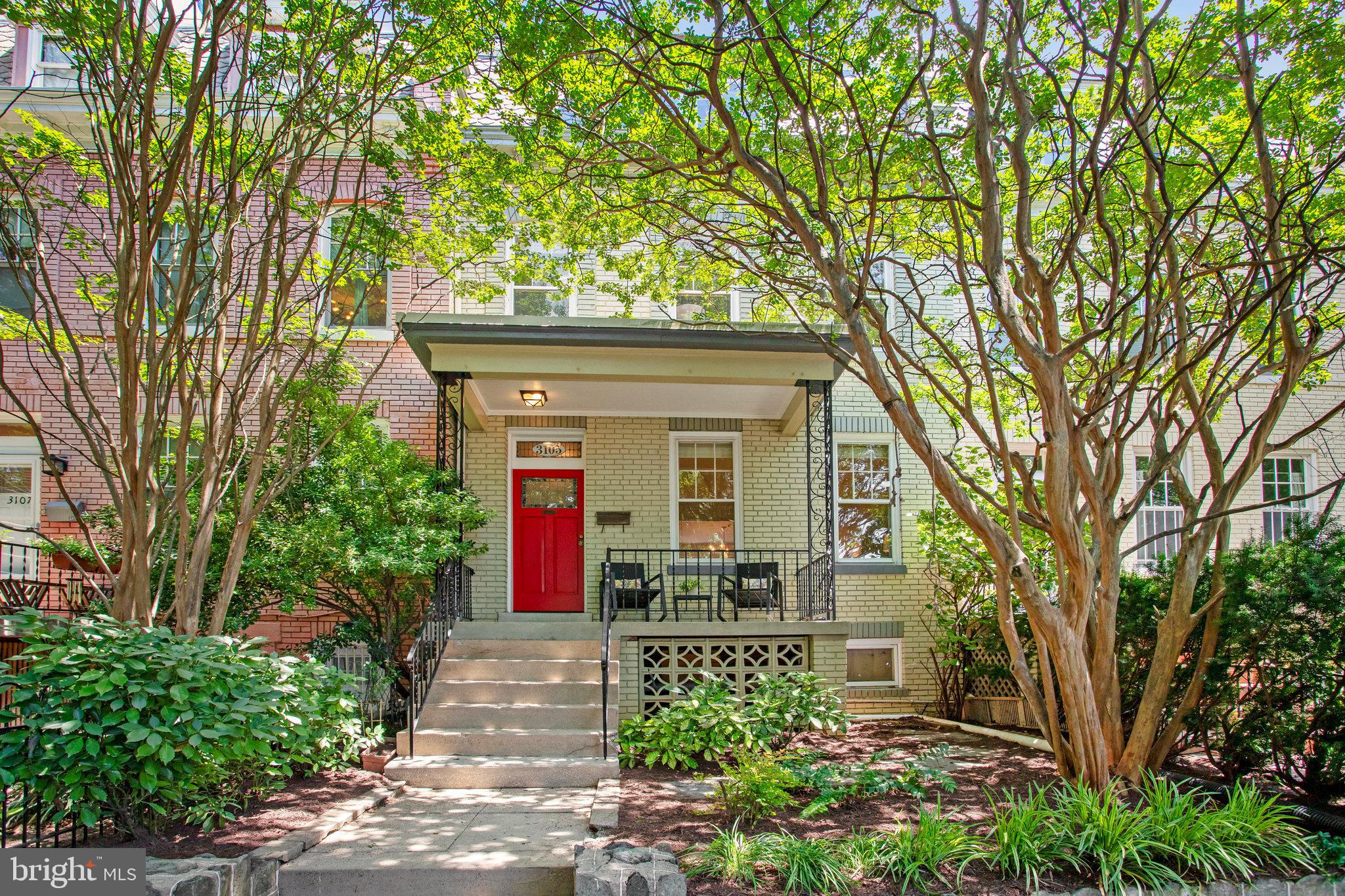 Welcome to 3105 17th St NW, a beautiful 4 bedroom, 2 bathroom townhouse with a private patio and solar panels located in the heart of Mount Pleasant. This home exudes charm and comfort throughout, with hardwood floors, high ceilings, wood-burning fireplace, exposed brick, and many thoughtful upgrades.
As you enter through the covered porch, you’ll notice the charming stained glass above the door. Walk inside to the foyer that leads to a large living room anchored by a wood-burning fireplace. The living room is open to the spacious and light-filled dining room that easily accommodates a table for six or more — perfect for entertaining. The thoughtfully renovated kitchen opens to the dining room, and it features a breakfast bar, open shelving, and lots of cabinet storage with pull-out shelving for easy organization! Step through the large glass door off the kitchen to the private back patio and fenced garden, a rare retreat that is ideal for relaxing outdoors or hosting friends.
Upstairs, you'll find three bedrooms — two generously sized and one smaller one which is ideal for a guest or nursery space — along with a beautifully renovated full bath. The primary bedroom is located at the front of the house and features a large closet with built-in shelving. The second spacious bedroom has a balcony overlooking the back patio—just right for morning coffee or checking the weather before starting your day. Behind a doorway in the hallway are ladder steps to a finished attic loft with incredible treetop views — an inspiring spot for a home office, yoga studio, or creative space. You can even hear the lions at the zoo on quiet mornings!
The recently renovated lower level adds valuable versatility to the home. It includes a second full kitchen, a full bath, a bonus room, and a separate back entrance — perfect as an in-law suite, au pair quarters, or guest space. The laundry room location near the separate entrance allows access from the upper levels without disturbing guests in the in-law suite.
The roof was replaced in 2019 with a durable Fibertite system, and solar panels were installed at the same time. These panels nearly eliminate the electric bill — even with central A/C running during the District’s hottest months. Rental parking available nearby.
The home is ideally situated just blocks from Mt. Pleasant Street shops and restaurants, Rock Creek Park, the National Zoo, the Columbia Heights Metro, nearby commuter bus lines , and Adams Morgan. If you love being close to the vibrant and charming Mount Pleasant community and also having the space for entertaining and comfortable living at home, this property is one you cannot miss.