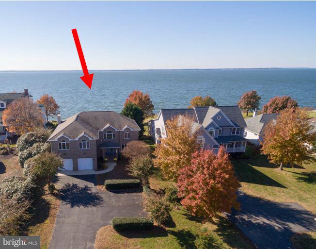 Exceptional home in sought-after, waterfront community. Home is in best location in community on quiet cul-de-sac street with private community beach at the end of the street. You can walk to your own deeded boat slip, the pool, tennis courts or tot lot from this house. Wonderful floor-plan, excellent storage, large rooms all with huge closets. Family room with wet bar and fireplace, kitchen and all weather-porch open onto large deck. Views from just about every room in home. Upper level offers 2 master suites; both with walk-in closets and large baths plus each room has a private balcony overlooking the River and sunset view. Spacious, level front yard on waterside of home. Paved driveway offers ample overflow parking for guests. Must see this immaculate home!