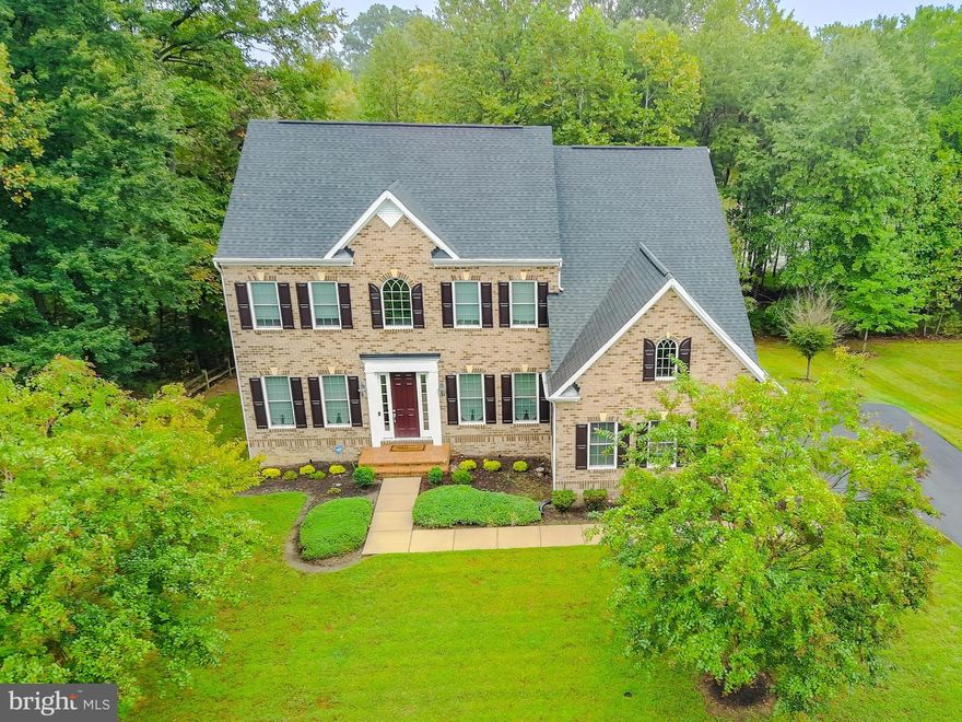 MAJOR PRICE REDUCTION!!! Welcome to 13500 Mary Bowie Parkway! Nestled in the prestigious gated Oak Creek golf course community, this exquisite 5-bedroom, 4-bath colonial blends modern elegance with timeless charm on a picturesque lot in Upper Marlboro. With resort-style amenities, secure gated living, and direct access to one of the region’s most celebrated golf courses, this home offers a lifestyle as impressive as the residence itself.

Step inside to discover a bright, open-concept layout featuring gleaming hardwood floors throughout the main level. The gourmet kitchen is a chef’s dream with a massive center island that seats six, granite countertops, stainless steel appliances, designer lighting, and a butler’s pantry for seamless entertaining. The kitchen flows into a sunlit dining area and the grand two-story family room, where soaring ceilings, oversized windows, and a dramatic overlook create a warm and inviting atmosphere.

The main level also boasts multiple living spaces, including a formal sitting room, a private study, and an expansive family room complete with a wet bar. A dual staircase offers convenient access from both the foyer and kitchen, enhancing the home’s thoughtful design.

Upstairs, retreat to the luxurious owner’s suite featuring tray ceilings, a spa-inspired bath, generous walk-in closets, and a private walkout deck—perfect for morning coffee or evening relaxation. Four additional bedrooms and beautifully appointed bathrooms provide comfort and privacy for family and guests.

The fully finished lower level expands your living space with endless possibilities: enjoy a billiards area, theater room, wet bar, and open recreation space designed for entertaining or unwinding at home.

Outdoors, the large, level backyard offers plenty of room for gatherings and play, while the side-load garage enhances curb appeal. Conveniently located just minutes from shopping, dining, and major commuter routes, this spectacular property combines comfort, style, and the best of golf course living.