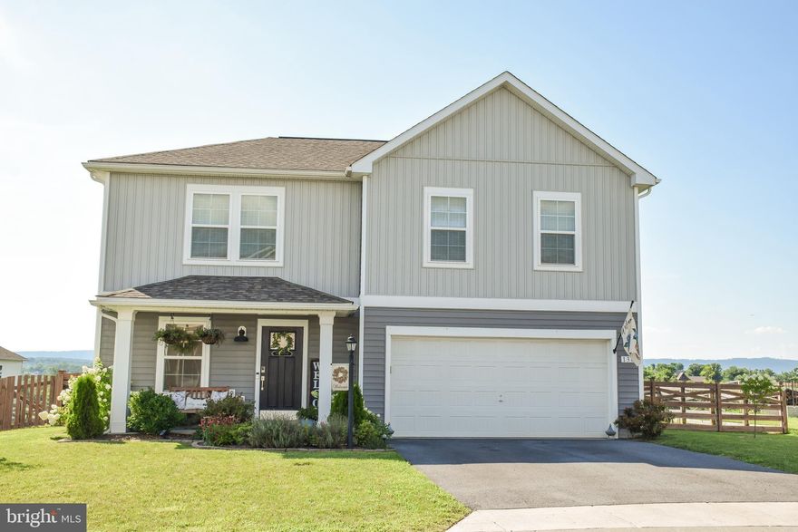 Welcome to this exceptional 4-bedroom, 2.5-bath home in  Morning Dove II Estates in Bunker Hill, WV. Nestled in a peaceful setting with picturesque pastoral views, this beautifully maintained home offers the perfect blend of comfort, elegance, and functionality.

This home is filled with many upgrades, featuring luxury vinyl plank (LVP) flooring in most rooms for a stylish and low-maintenance finish. The gourmet kitchen is a chef’s dream—complete with a butler’s pantry, recessed lighting, modern finishes, and a dedicated coffee bar area for your morning routine or evening wind-down. The living room features a cozy electric fireplace, ideal for relaxing or entertaining.

Upstairs, the spacious primary suite is a true retreat with its own electric fireplace, custom built-ins, a large walk-in closet, a luxurious walk-in tiled shower, and a double-sink vanity. All bedrooms include ceiling fans for added comfort, and the laundry room is conveniently located on the bedroom level.

Step outside through the patio doors to a concrete patio that leads to a fully fenced, beautifully landscaped backyard—perfect for outdoor enjoyment. A playset is included, making it ideal for families.  Additional highlights include a 2-car garage, scenic views, and tasteful finishes throughout.

Don’t miss your chance to own this stunning, upgraded home—schedule your private showing today!

All room measurements are approx.