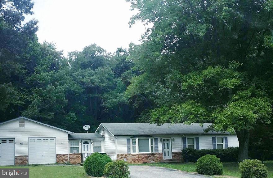 Handyman s dream!!! This home sits on a flat 1 acre lot that backs up to woods. Its oversize 2-car garage includes a bedroom/den, bathroom, and a storage area. It is a MUST SEE!
