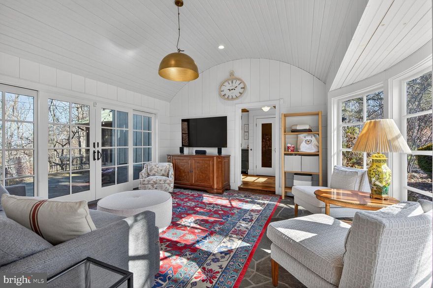 offer deadline is Tuesday 3/10 at 2pm....SPECTACULAR DESIGN blending historic character with modern luxury on a beautifully landscaped 1.5-acre fenced lot. A stone fence, decorative iron arch and gate, and circular driveway create a striking first impression. Dutch door with period twist doorbell opens to a foyer featuring repurposed quarter-sawn oak floors (from barn siding), shiplap walls, antique door surrounds salvaged from a North Carolina manor, tongue-and-groove ceiling, recessed and accent lighting. A nook with built-in bookcases and stained glass compliments the foyer. The powder room showcases exposed brick, pedestal sink, shiplap, stained glass, and a solid wood pocket door. The primary suite offers vaulted ceilings with exposed beams, chandelier, built-ins, window seats with storage, two closets (including walk-in), custom Hunter Douglas Duette honeycomb blinds, and continued quarter-sawn oak flooring. The bath includes a walk-in shower with three heads (rain, handheld, stationary), bench, storage niche, glass door, and steam plumbing, while a antique dresser vanity, separate water closet with wood and textured glass door, built-in storage cabinet with repurposed shutter doors, and layered lighting complete the room. The open-concept kitchen features custom shaker cabinetry with glass doors, pantry cabinet, roll-out shelves, lazy Susans, spice pull-outs, wine storage, crown molding, and a custom peninsula with wood countertop, refrigerator and freezer drawers, and open shelving. Premium appliances include a 6-burner dual-fuel convection oven (2024), pressed tin and wood range hood, Sub-Zero refrigerator with cabinet panel, new dishwasher with cabinet panel (2025), porcelain apron sink, soapstone counters, brick backsplash, and abundant recessed, under-cabinet, and pendant lighting. Multiple windows flood the space with natural light. Laundry closet with side-by-side front loaders and shelving. The kitchen opens to a vaulted living room with exposed beams, Restoration Hardware chandelier, large stone gas fireplace with antique mantel, built-ins, shiplap, Sony sound system, and French doors. Dining room offers a wall of windows, built-in hutch, and recessed lighting. A screened porch with vaulted beams, skylights, stone floor, gas-assisted wood-burning fireplace, heater, ceiling fan, speakers, and corbel accents extends living space outdoors. The family room features a barrel tongue-and-groove vaulted ceiling, heated stone floors, shiplap, chandelier, and a salvaged rounded bay window; sliding doors open to an expansive stone patio with professional gas grill (smoker, rotisserie, side burners) and café lighting. Bedroom two includes repurposed snow-fence wood flooring, tongue-and-groove ceiling, shiplap wainscoting, recessed lighting, and custom blinds. The hall bath offers a vintage stained-glass door, antique dresser vanity with marble and vessel sink, subway-tile walk-in shower with dual heads, pressed tin ceiling, and hex tile floor. Bedroom three features snow-fence flooring, built-ins, walk-in closet with custom shelving, tongue-and-groove ceiling, and shiplap details. Additional highlights: mudroom area with Dutch door and covered side porch to the garage; garage with Level 2 charger, carriage-style doors, epoxy floor, vaulted ceiling, insulated storage/workshop, and extra refrigerator; storage shed; extensive stone hardscape and mature landscaping (hydrangeas, Japanese maple, boxwoods, peonies, crape myrtle, magnolia). Original stone Better Homes & Gardens kit house with board-and-batten and shingle additions, standing-seam metal roof, Vanguard generator, dual-zone HVAC (one replaced 2024), Nest thermostats, double-pane windows, tankless water heater (2024), water treatment system, and flood lights on each corner.  Near many vineyards, hiking trails, restaurants and retail.  Be sure to see the video attached to the virtual tour.