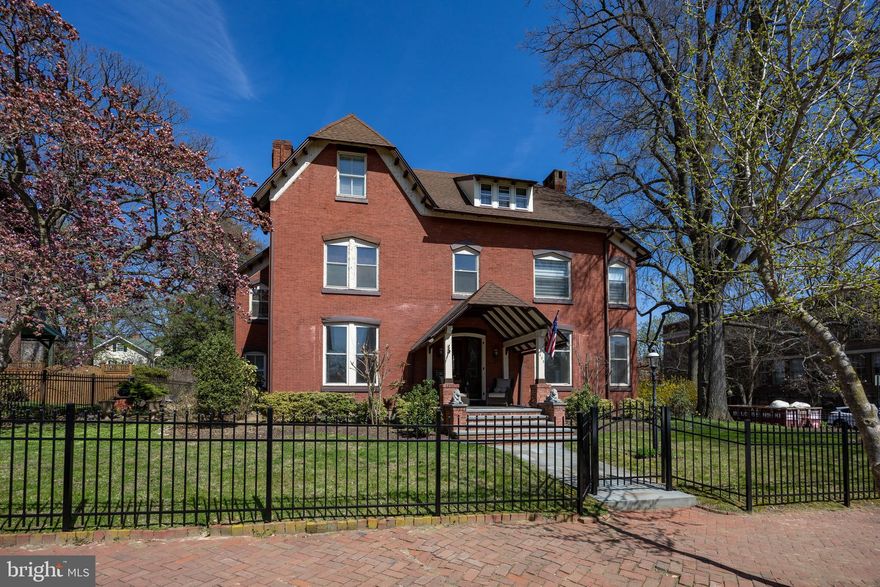 Stunning Victorian in the heart of West Chester Borough — The former Residence of Anna Darlington and The Brinton Family, where old‑world charm meets modern luxury. This gracious 6‑bedroom, 2 full / 2 half‑bath home showcases vaulted ceilings, large period windows, crown moldings, wainscoting, chandeliers, arched openings and wide stairwells alongside a thoughtfully designed contemporary addition.
The gourmet custom Hazley Bros.  kitchen and great room are a showpiece: a large granite island, a sea of custom soft‑close cabinetry with LED lighting, Sub‑Zero refrigerator, Bosch range and oven, custom freezer drawers, warming drawer, and a built‑in bar with granite counters, bottle refrigerator, ice machine, bottle and glass storage with LED backlighting. The family room soars with high vaulted ceilings, skylights, ceiling fan and a wood  fireplace — an ideal blend of light, warmth, and luxury.
Formal living and dining rooms capture the home’s period elegance; bedrooms are generously proportioned. The property includes a detached two‑car garage with finished space above — perfect for a home office, gym area or rental apartment — plus an off‑street private driveway. Outside, enjoy a fully fenced backyard with stone patio for entertaining, room for gardening, and a large fully covered front porch,  Practical extras: full unfinished walkout basement with workshop and abundant storage, excellent potential to finish additional living space. Experience historic Borough character with Modern conveniences just moments from many fine restaurants like Pietros' Prime, Limoncello, and Avalon. Experience all the boutique shops on Market and Gay St. A short walk to the West Chester Country Club, Grower's Market,  many coffee shops and Public Transit.  This is the height of West Chester Boro living! Schedule your tour today!