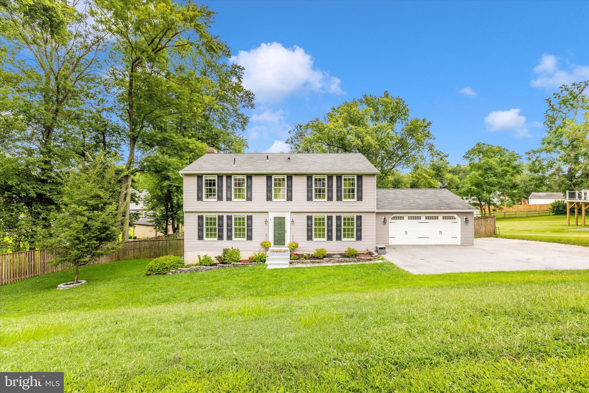 Welcome to 5606 Manor Drive, tucked away on a peaceful cul-de-sac in desirable Woodbine Acres—no HOA!
From the moment you arrive, you'll appreciate the pristine landscaping, mature trees, and a large, private fenced backyard—all setting the tone for this warm and welcoming home.
Inside, freshly painted walls and gleaming LVP flooring invite you in. This spacious 4-bedroom, 2.5-bath home offers timeless charm paired with thoughtful updates, including a fully fenced backyard and serene tree-lined views.
As you enter the home, the flexible front room off the foyer can serve as a living room, home office, or playroom—tailored to fit your lifestyle.
At the heart of the home, the open-concept kitchen shines with granite countertops, stainless steel appliances, a double oven, ample cabinetry, and a large island. You will love the oversized sink that sits beneath a window that overlooks the backyard. A sliding door off the kitchen leads to a private deck—perfect for outdoor dining or effortless entertaining.
The adjacent family room features a cozy wood-burning fireplace insert with brick hearth and mantle creating a warm ambiance. The formal dining room provides a lovely setting for dinner or hosting guest. A powder room completes the main level.
Upstairs, brand-new carpet adds comfort throughout. The spacious primary suite features an en-suite bath with dual vanities, an oversized updated shower, large linen closet, and two closets—including a walk-in. Three additional bedrooms and a full hall bath round out the upper level.
The walkout lower level is ready for your vision, with built-in shelving and a laundry area with utility sink. A spacious two-car garage provides plenty of room for tools, toys, or storage.
Peaceful living meets practical comfort—don’t miss your opportunity to call this beautiful home yours!