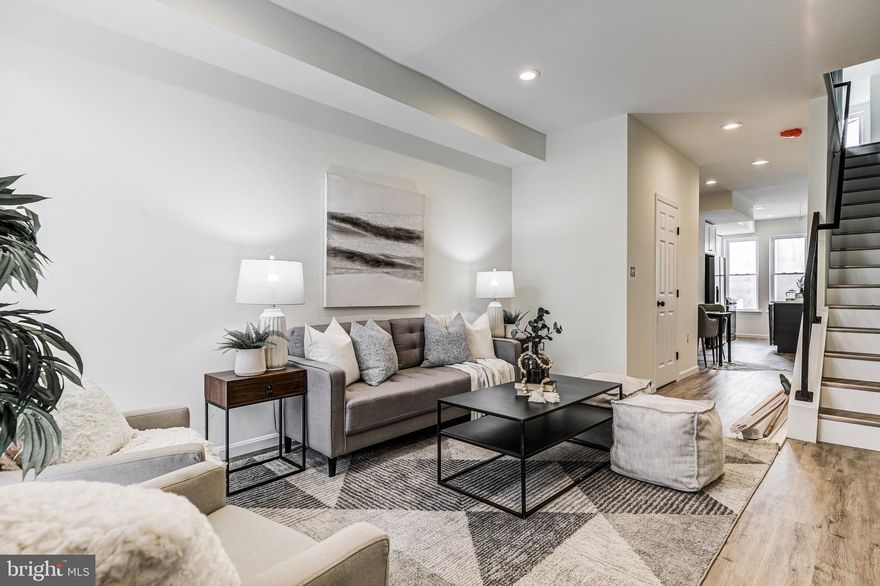 Welcome to Middle East Baltimore's newest beautifully renovated 3bed/ 3 .5bath rowhome! The main floor of the home offers an open floor plan with new tile and hardwood flooring and recessed lighting. The kitchen has custom cabinetry, stainless steel appliances, and quartz countertops perfect for meal prepping and entertaining. Upstairs you will find a spacious primary bedroom equipped with  mood lighting , a sizeable secondary one, and two updated bathrooms with sleek tiling. The basement is finished and has an additional bedroom and full bathroom. The exterior of the property is just as beautiful with a brick front. The back of the property can be accessed from the kitchen. Rear Parking Pad included!!! This property qualifies for Johns Hopkins Live Near Your Work Program with up to $17,000 in grants.  Be sure to check with your lender for additional qualifying incentive programs.