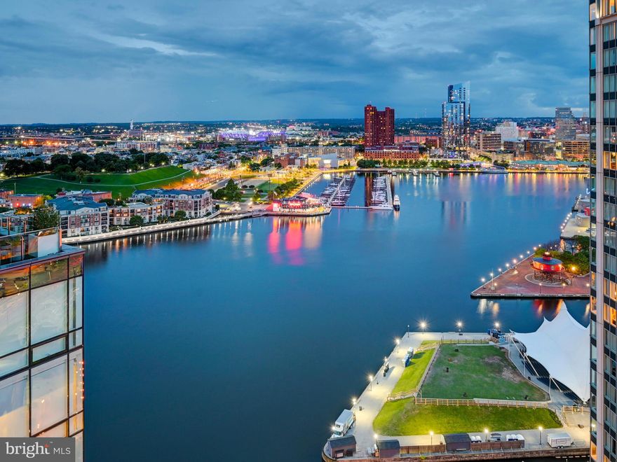 Breathtaking Panoramic views of the Inner Harbor from the most Luxurious Building, located in the most coveted Zip Code in Baltimore City, the Four Seasons Private Residences in Harbor East.  This 2 Bedroom 2 Bathroom Residence, located on the 24th Floor, features an inviting Open Floor Plan with sprawling Chevron Walnut Wood Floors throughout and floor to ceiling windows in every room to ensure maximum exposure to sunlight and gorgeous views. The Custom gourmet Kitchen is perfectly appointed with Miele appliances and centered around an elegant waterfall marble countertop island that is open to the living space which includes an outdoor Patio where the dramatic views continue. The Primary suite is complete with dressing room and lavish en-suite marble bath w/ large walk-in shower and stand-alone soaking tub. Four Seasons 5-Star Amenities include a Residence Only front entrance and resident only amenities level which encompasses the entire 28th floor and the views continue.  This private resident level includes an infinity edged Salt Water indoor heated pool with an open air rooftop Sundeck, a Sauna - complete with its own Harbor Views, fitness room, a large gathering and event space which consists of large dining area, lounge spaces, conference room, billiard area, kitchen space, indoor and outdoor fireplaces, multiple outdoor seating spaces, outdoor grilling area, and an outdoor AstroTurf dog walking space. Four Seasons Private Residences Baltimore, a seamless blend of sophisticated style, lavish amenities, and the exemplary service of the world's preeminent hotelier.