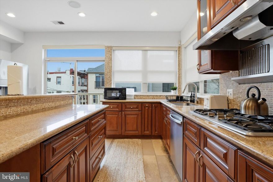 Located on a quiet block in the heart of Northern Liberties, 1011 N Orianna Street presents a rare opportunity to own an exceptionally large, new-build from 2009 offering over 5,000 square feet of living space with extraordinary flexibility. Configured with 8 bedrooms and 5.5 bathrooms, the home features multiple living areas, two full kitchens, and a lower-level kitchenette, creating an ideal setup for intergenerational living, large households seeking privacy within a shared home, or buyers looking to continue operating a high-performing short-term rental investment that is on Airbnb and VRBO. The thoughtful layout allows the property to function almost like several homes under one roof. The main level includes a spacious kitchen, living and dining areas, two bedrooms, and access to a rear deck and shared patio. The finished lower level provides additional living space with a kitchenette, two bedrooms, a full bathroom, and direct patio access. The second floor offers another kitchen, multiple living areas, a dining space, and a half bath, while the upper level contains four additional bedrooms, including a primary suite with an ensuite bath, plus convenient second-floor laundry. Multiple gathering areas and kitchens allow residents or guests to spread out comfortably while still enjoying shared spaces. Just steps from the vibrant restaurants, cafés, parks, and boutiques that define Northern Liberties, the home offers easy access to Old City, Center City, and major cultural destinations, including the Philadelphia Museum of Art and The Franklin Institute. With its scale, flexible layout, and prime location in one of Philadelphia’s most dynamic neighborhoods, 1011 N Orianna Street represents a unique opportunity for both homeowners and investors alike.