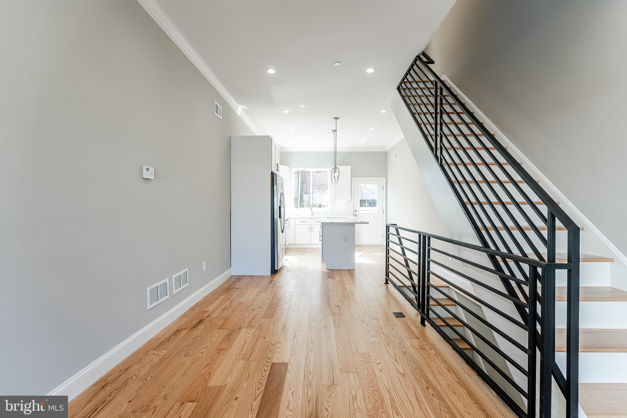 Welcome to 1309 S 31st St., an extraordinary new construction that showcases luxury and modern design. Created by the industry's top talent, this home offers meticulous attention to detail and a seamless blend of style and functionality. This 3-story, 3-bedroom, 3-bathroom residence is filled with light and space, featuring an open floor plan, soaring ceilings, and elegant wide plank hardwood floors throughout.
1st Floor: As you step inside, you're greeted by an open concept living area that seamlessly connects the living room, dining room, and kitchen. The impressive 10-foot ceilings and large windows flood the space with natural light, accentuating the solid oak hardwood floors. The kitchen is a chef's dream, featuring 42-inch cabinetry, sleek quartz countertops, a designer porcelain backsplash, and an expansive quartz island with storage. Stainless-steel appliances complete this culinary haven. A rear door leads to your private outdoor area, perfect for al fresco dining or quiet relaxation.
2nd Floor: The second floor offers two spacious and light-filled bedrooms, each with 9-foot ceilings and walls of windows that invite the outdoors in. The handsome hardwood floors continue on this level. The guest bathroom is a model of simplicity and beauty, with double sinks, quartz countertops, and elegant porcelain flooring.
3rd Floor: The master suite on the third floor is a sanctuary of luxury, with soaring 10-foot ceilings and an abundance of natural light from oversized windows. An entire wall of closets provides ample storage. The spa-like bathroom is an oasis, featuring porcelain surround, a 72-inch custom quartz vanity with double sinks, a breathtaking walk-in frameless glass shower with a rainmaker, and modern fixtures. This level also includes a custom-built wet bar with cabinets, a wine cooler, and a sink, leading to the pièce de résistance—the roof deck.
Roof Top: Experience unobstructed 360-degree views of the city skyline, stadiums, and bridges from the fabulous roof deck. It’s the perfect spot to entertain guests or enjoy a peaceful morning coffee with a view.
Lower Level: The fully finished lower level offers high ceilings and a gorgeous spa bath, making it ideal for an in-law suite, home office, or gym. Its versatility caters to a variety of needs and preferences.
Additional features include an approved tax abatement that offers financial benefits and high-end finishes throughout the home, thoughtfully crafted with quality and style in mind.
1309 S 31st St. is not just a home; it’s a testament to modern design and luxurious living. With its incredible features and prime location, this property is a rare find. Who will be the next lucky owner to buy this home from one of the best and most detailed center-city builders around?