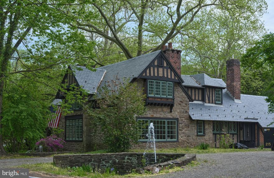 A truly exceptional opportunity to own a landmark home in one of Pennsylvania’s most treasured historic districts. This enchanting Tudor Revival residence, designed and built in the early 20th century by renowned architect, craftsman, and artist Morgan Colt, is a cornerstone of the Phillips Mill Historic District—recognized on the National Register of Historic Places. ​Originally a stone barn, Colt transformed the structure into a captivating home featuring handcrafted woodwork, wrought iron details, and leaded glass windows. The property is part of the "Little English Village," a collection of Gothic and Tudor-style buildings that Colt developed, reflecting his dedication to the Arts and Crafts movement. ​Nestled between the Delaware River and the canal path, the Morgan Colt House offers a serene setting just minutes from downtown New Hope. The surrounding area is steeped in artistic heritage, having been home to the New Hope Art Colony and figures like Edward Redfield and Daniel Garber. ​This property presents a unique opportunity for preservationists, artists, or those seeking a distinctive residence rich in character and history. With its architectural significance and idyllic location, the Morgan Colt House stands as a testament to early 20th-century craftsmanship and the enduring legacy of the New Hope art community.​ Additional two story Carriage home with fireplace  and  two story Guest Cottage with large fireplace A total of 3 buildings and small garden shed.