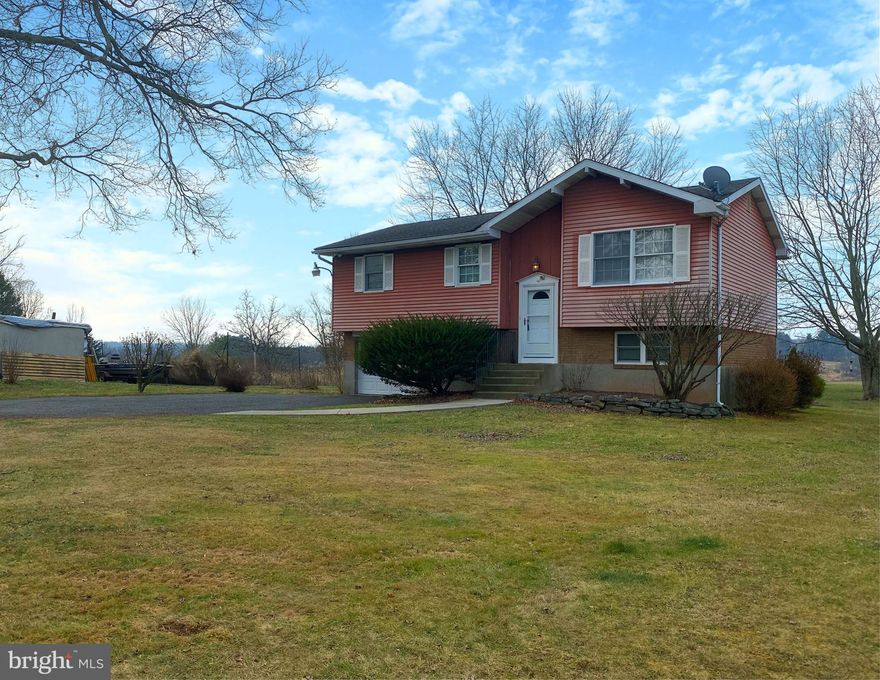 Beautifully updated split-level single-family home located in Springfield Township, Bucks County, within the Palisades School District. This well-maintained property features an open-concept main level with hardwood floors and newer windows. The updated kitchen offers soft-close cabinets, granite countertops, tile backsplash, stainless steel appliances, a convection oven, ice maker, pantry and recessed lighting. The walk-out lower level provides flexible living space for a family room, office, or storage. Additional features include ceiling fans, window A/C units, blinds, and a washer and dryer. Exterior amenities include a large yard, 1-car garage, and private parking for up to 4 vehicles. Convenient location close to local amenities and major routes. This home offers modern upgrades, comfortable living, and a peaceful setting.