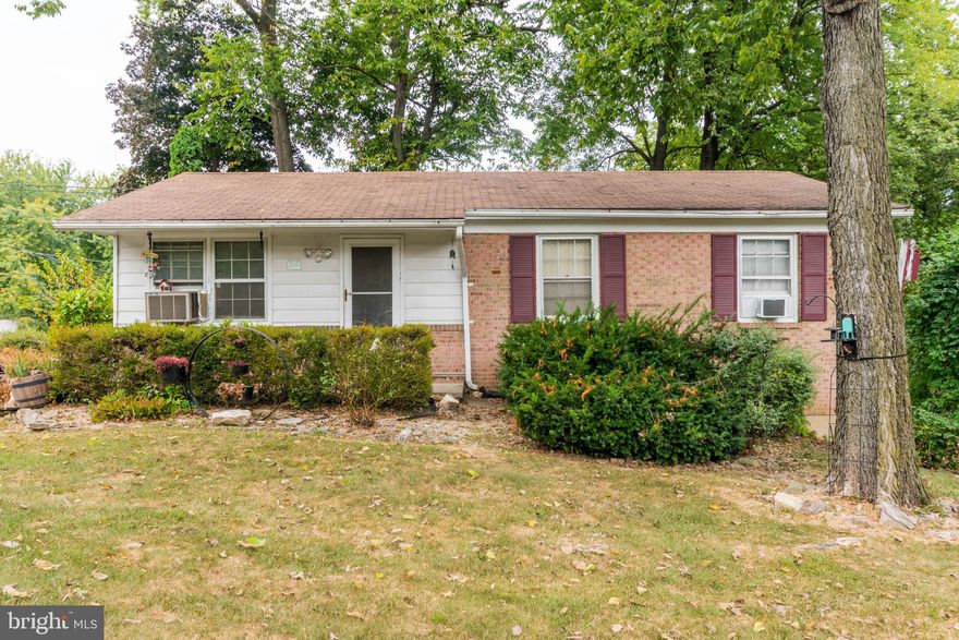 PRICE REDUCTION!  Are you looking for a Rancher – At a Great Price With NO HOA??    This charming 3-bedroom, 1.5-bath brick-front rancher is the perfect choice and a great value for the price! Situated on a spacious corner lot, this home offers both comfort and convenience with not only one but two driveways making plenty of parking for you and your guests. The home is nestled comfortably among mature trees, contributing to a shaded and peaceful atmosphere. Enjoy outdoor living with a fully fenced yard consisting of a mix of grass and lovely landscaping - which includes a combination of low shrubbery, potted plants, and decorative elements. Inside you'll love the classic parquet hardwood floors, family room, and spacious kitchen with ample table space—perfect for everyday meals or entertaining. The main floor also includes a convenient stackable washer and dryer. The full unfinished basement provides tons of storage or potential for future expansion, and the wood stove adds a cozy touch in cooler months. Affordable, move-in ready, and full of potential—schedule your showing today!