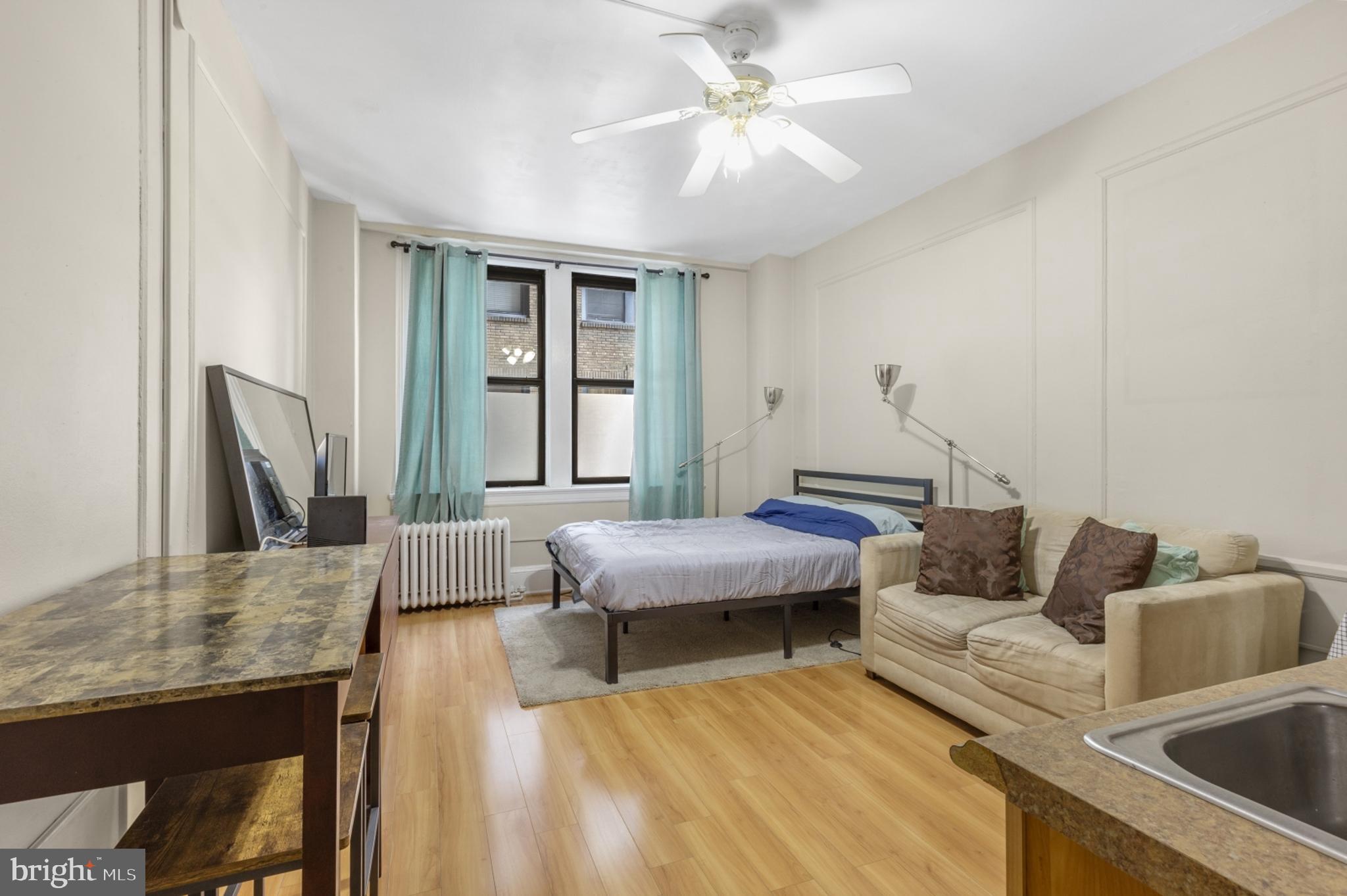 Welcome to 1324 Locust St #329! This is a lovely 3rd Floor Studio condo in the incredible Arts Condominium with unbelievable building amenities. The bright and spacious open floor plan offers wood floors with a ceiling fan for year-round comfort. Big windows fill the room with natural light - perfect for plant lovers. The efficient kitchen offers tile flooring, tile backsplash, a mini-fridge, and a hotplate. Just behind the kitchenette, you'll find a closet with a built-in mirror for added convenience. The bathroom features stylish black-and-white tiling, a full-size bathtub/shower combo, and a handy medicine cabinet. This studio is the perfect blend of comfort and functionality. Located in the Arts Condominium with building amenities that include a 24-hour front desk concierge, elevators, a stunning lobby with secure entry, fitness center, resident lounge with TV and couches, and laundry room. Schedule your showing today!