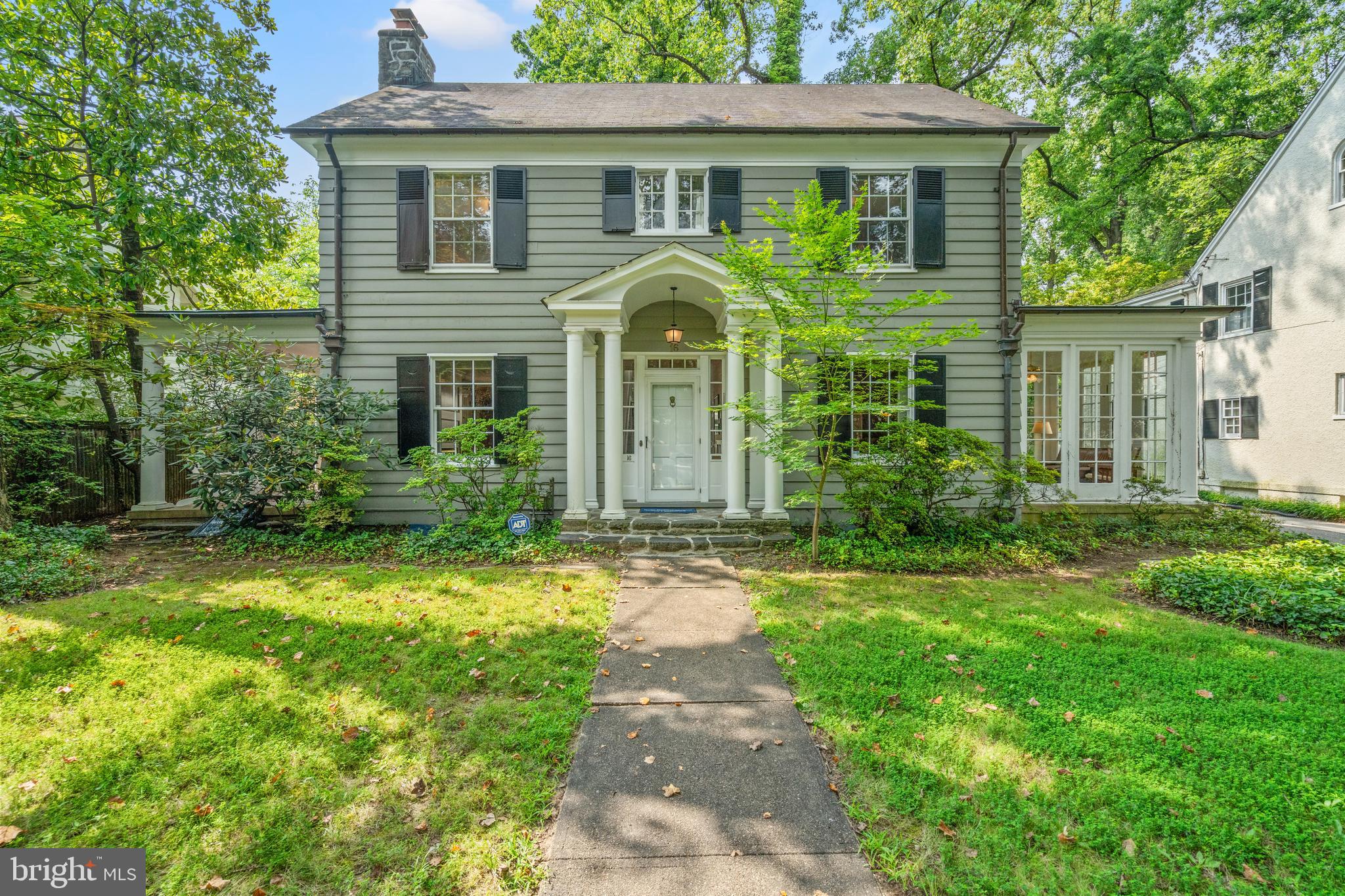Gracious Colonial on Coveted Block. Situated on one of the most desirable streets in Chevy Chase Village, this classic center hall Colonial offers timeless architecture, generous proportions, and a serene garden setting. Set on a deep, beautifully landscaped lot with a detached two-car garage, the home features tall ceilings, abundant natural light, and a gracious flow across four finished levels.
The main level showcases a large, welcoming foyer. The spacious formal living room features a wood fireplace and custom built-ins, along with access to a large, covered side porch overlooking the lush garden with mature landscaping. The formal dining room opens to a sun-filled den with floor-to-ceiling windows on three sides. A vintage butler’s pantry with an original bell system leads to a powder room and creates a natural flow between the kitchen and dining spaces. The kitchen is generously sized for casual dining, and the adjacent sunroom features skylights and a radiant-heated brick floor, offering everyday comfort and exciting potential for a spectacular future renovation.
Upstairs, the second level offers four well-proportioned bedrooms and three full baths, including an expanded primary bedroom flooded with light.
A wide staircase leads to the third floor, which includes a fifth bedroom, a full bath, and a cozy bonus room with built-in shelving and additional storage space.
The lower level features a finished recreation room, a large laundry room, and a spacious utility/storage area, providing flexible space for work, hobbies, or storage needs.
Additional highlights include solid hardwood floors on three levels, copper gutters and downspouts, a detached two-car garage, and an inviting brick patio bordering the lush garden. The house is full of charm and character and can be enjoyed today, while also presenting an exceptional opportunity for your personal updates.
Enjoy the unparalleled lifestyle of Chevy Chase Village—renowned for its tree-lined streets, brick sidewalks, and open green spaces—on a premier block that borders the Chevy Chase Club and is around the corner from the Village Hall. At the same time, the address is just moments away from public transportation, restaurants, shopping, and the Avalon theater. This special home offers the perfect blend of historic appeal, modern potential, and a vibrant, walkable community.