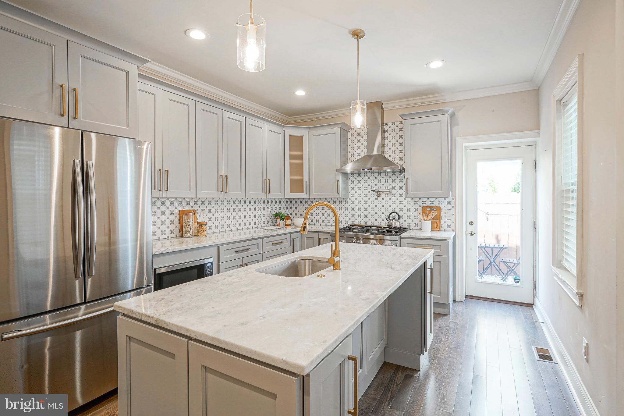 Welcome to 1813 Christian Street—a beautifully renovated, south-facing gem nestled on a quiet, tree-lined street in the heart of Graduate Hospital. This expansive 17’ wide, 3-story residence offers almost 2,500 sq ft of living space, featuring 4 bedrooms, 2.5 baths, a finished basement, a stunning roof deck, 2 zones of HVAC, and approximately 5 years remaining on a tax abatement.
As you step inside, you’ll be greeted by a bright and airy living room, perfectly designed for both relaxation and entertaining. A convenient half bath with stylish finishes is thoughtfully positioned on the first floor, just across from a striking exposed red brick accent wall near the dining room, adding a touch of classic charm to the space. The open dining area flows seamlessly into a sunlit chef’s kitchen, which boasts elegant quartzite countertops, brass hardware, a 6-burner stainless steel stove, and an eat-in island—offering ample space for both everyday meals and hosting guests.
Step outside to the serene back patio, an inviting oasis perfect for al fresco dining and summer gatherings. The beautiful pavers add a touch of elegance, while garden enthusiasts will appreciate the opportunity to work on their green thumb. Upstairs, you’ll find three generously sized bedrooms along with a chic full bathroom. On the third floor, the luxurious primary suite awaits, complete with an oversized closet featuring classic barn doors. The ensuite bathroom is a true sanctuary, featuring a double vanity, an oversized soaking tub, and a glass-enclosed shower. Beyond the bathroom, the roof deck offers breathtaking, unobstructed views of the city skyline, stretching from river to river.
The finished basement adds an additional 478 sq ft of versatile living space, perfect for a home office, gym, or playroom tailored to meet your lifestyle needs. Additionally, you’ll find the laundry and utility room here, providing ample storage space.
1813 Christian Street is ideally located just up the block from the YMCA, minutes from Rittenhouse Square Park, and offers quick access to Jefferson, Penn, CHOP, and Center City’s finest restaurants, stores, and cultural icons.